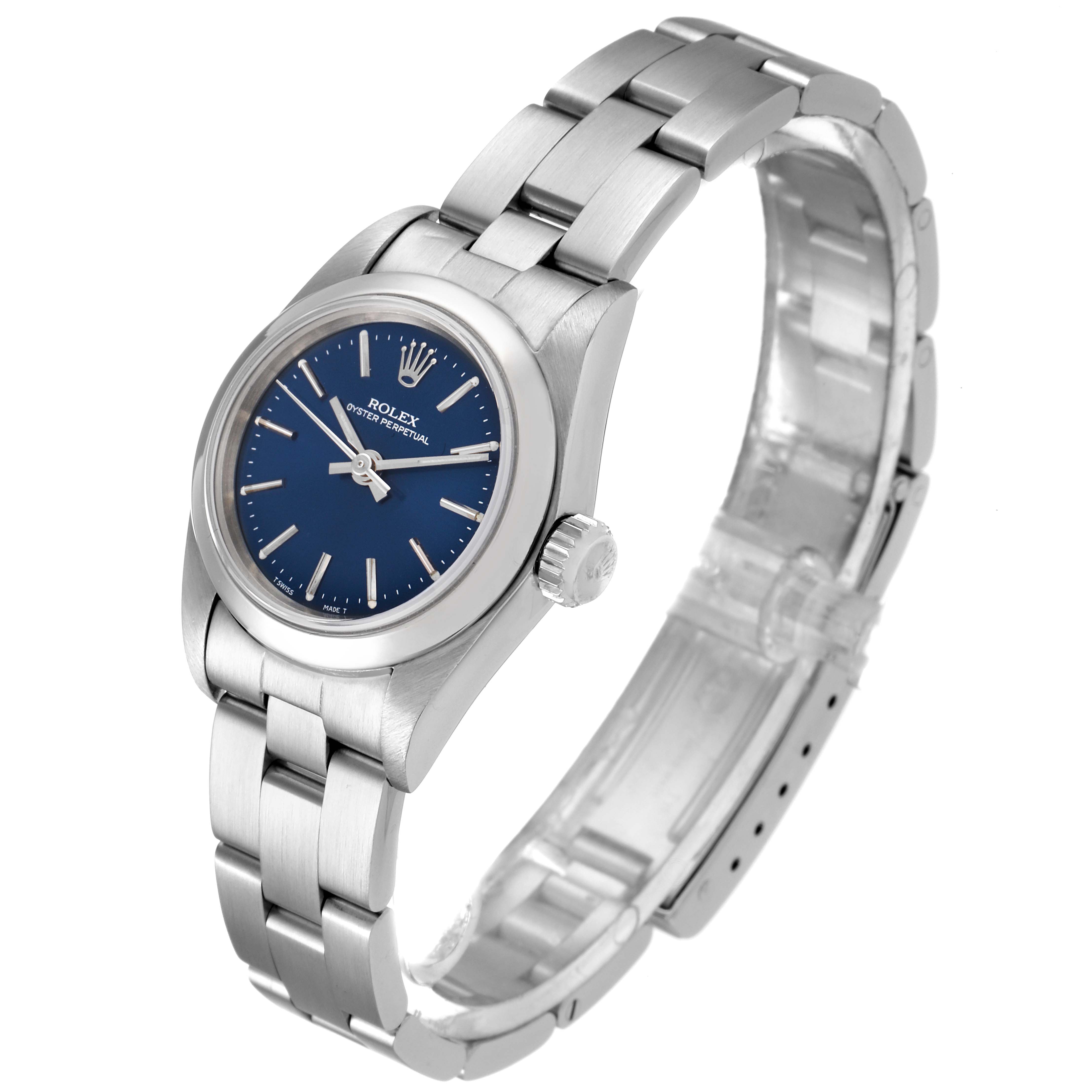 The Rolex Oyster Perpetual 67180 Women
s Stainless Steel Blue Dial 67180 Women
s Stainless Steel Blue Dial watch is shown from an angled side view, highlighting its bracelet, case, and blue dial.