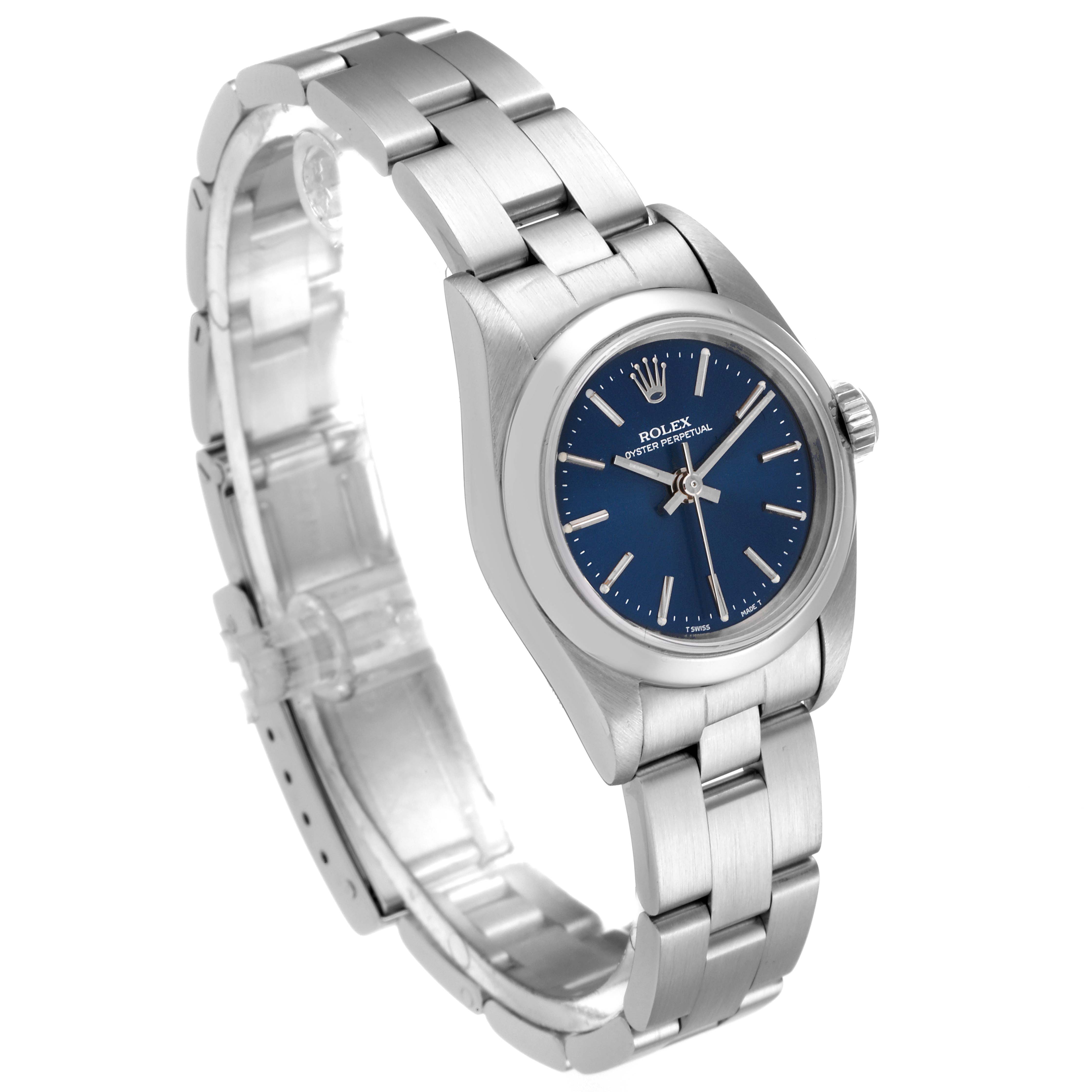 The Rolex Oyster Perpetual 67180 Women
s Stainless Steel Blue Dial 67180 Women
s Stainless Steel Blue Dial watch is shown at a slight angle, displaying its blue dial, metal bracelet, and clasp.