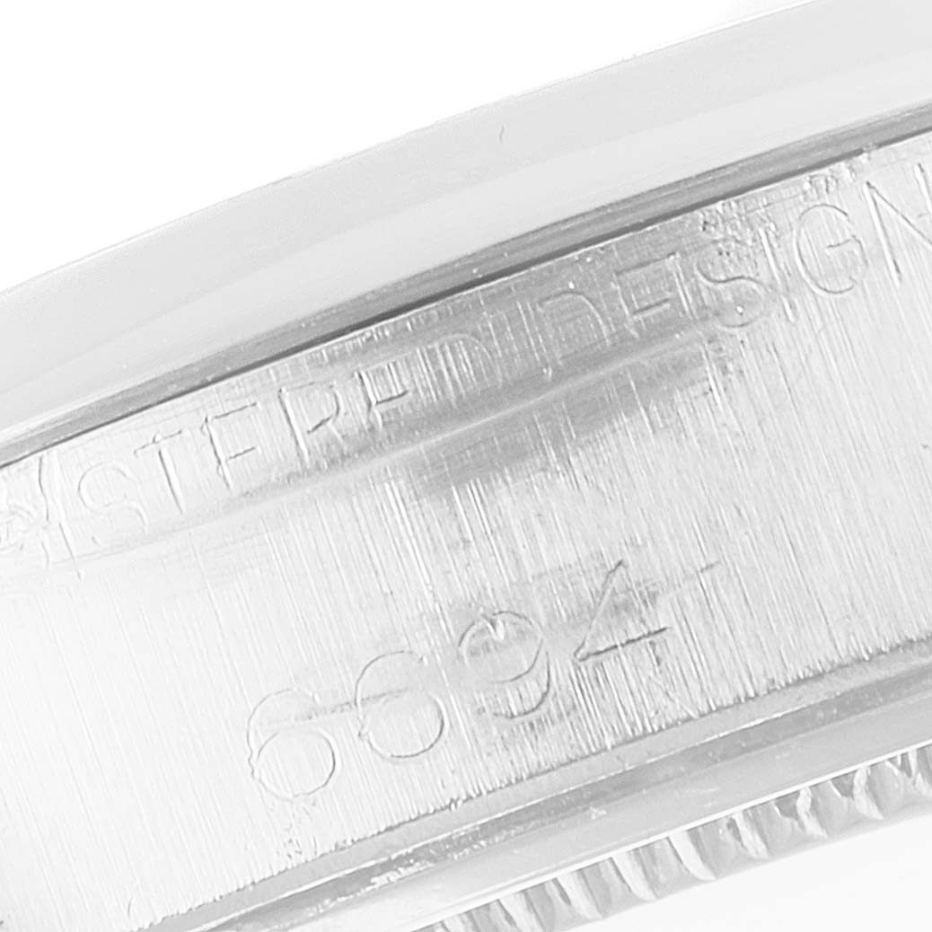 The image shows an angled close-up of the side engraving, featuring the model number on the Rolex Vintage Collection 6694 Men's Stainless Steel Silver Dial 6694 Men's Stainless Steel Silver Dial watch.