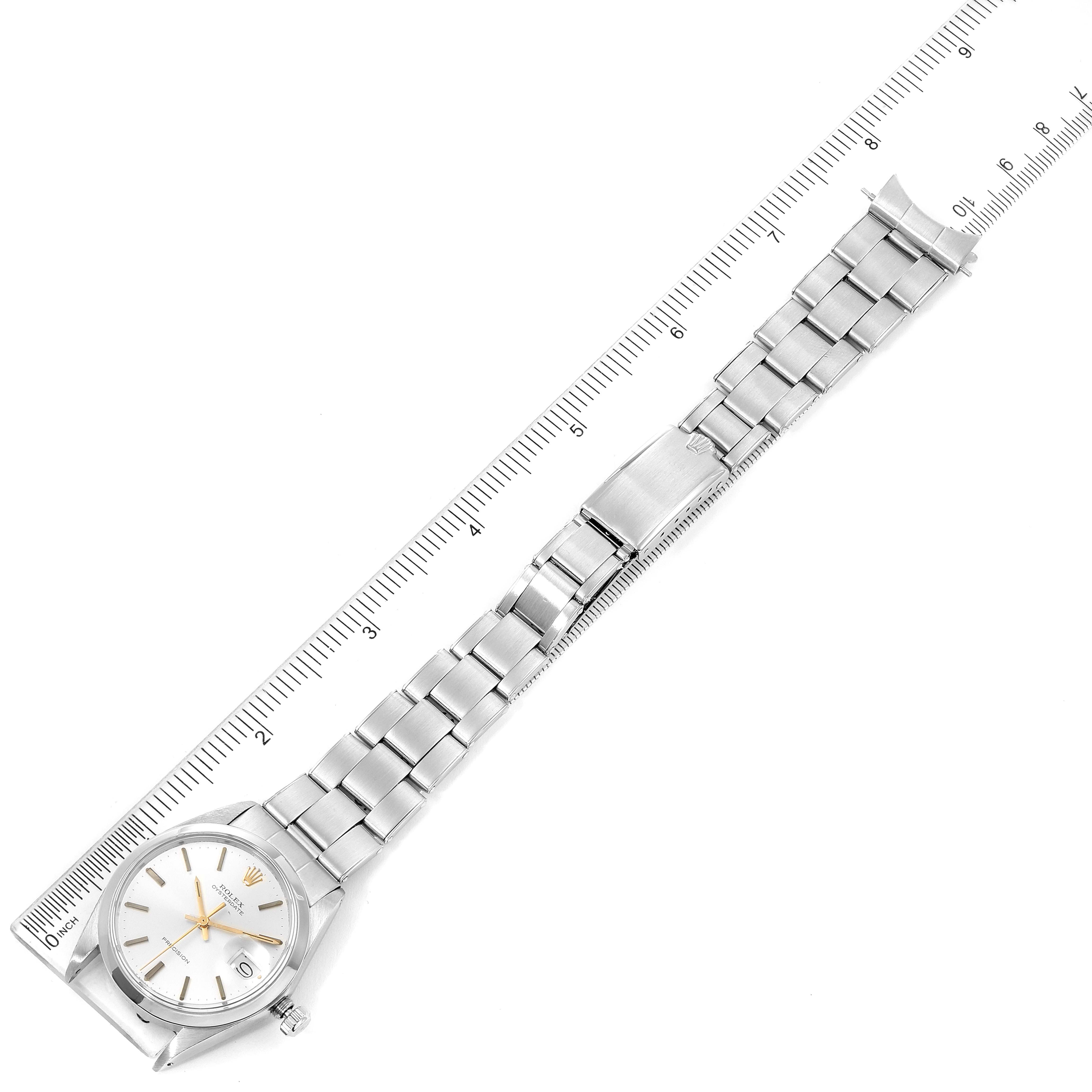 The image shows a top-down view of the Rolex Vintage Collection 6694 Men's Stainless Steel Silver Dial 6694 Men's Stainless Steel Silver Dial watch, including the dial, bracelet, and clasp, aligned with a ruler.