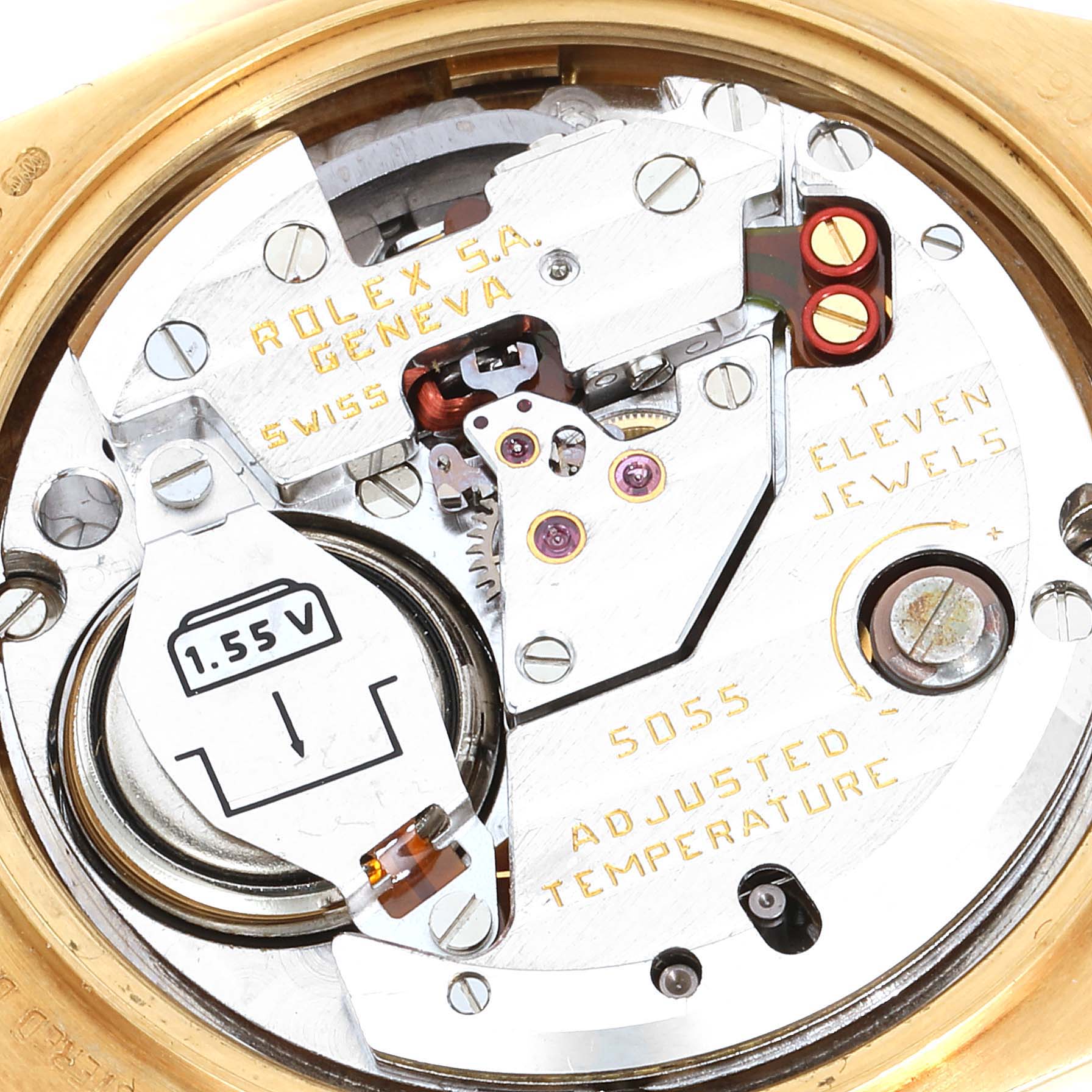 The image shows a close-up view of the movement mechanism of a Rolex Oysterquartz 19018 Men
s Yellow Gold Champagne Dial 19018 Men
s Yellow Gold Champagne Dial watch, revealing details of the components and engravings.