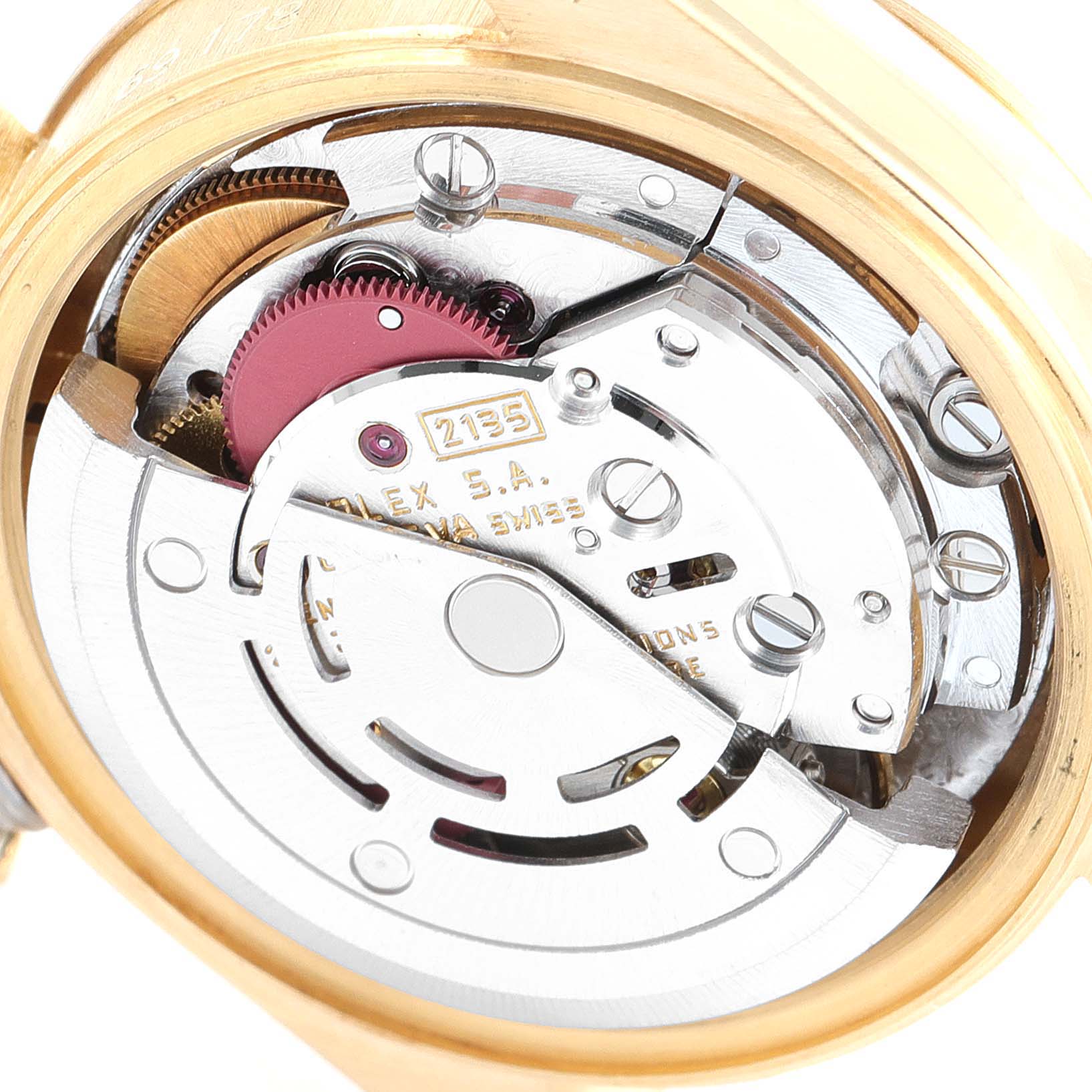 This image shows a close-up of the internal mechanism of a Rolex President 69178 Women's Yellow Gold Champagne Dial 69178 Women's Yellow Gold Champagne Dial watch, highlighting its intricate gears and components.