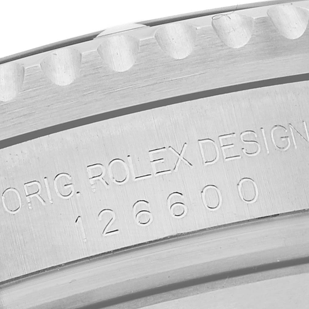 A close-up view of the Rolex Sea-Dweller 126600 Men's Stainless Steel Black Dial 126600 Men's Stainless Steel Black Dial model 126600, showing the engraved bezel and case inscription.