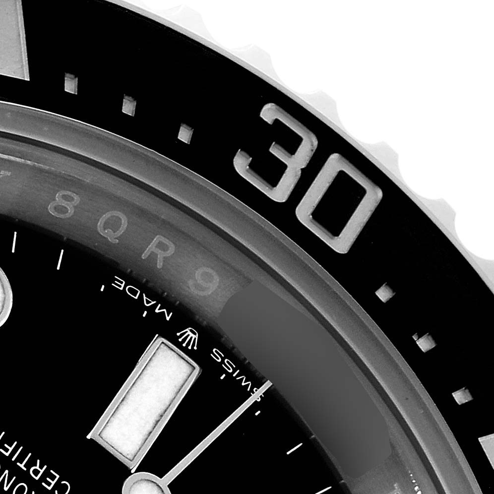 This close-up angle shows the bezel and part of the dial of the Rolex Sea-Dweller 126600 Men's Stainless Steel Black Dial 126600 Men's Stainless Steel Black Dial watch.