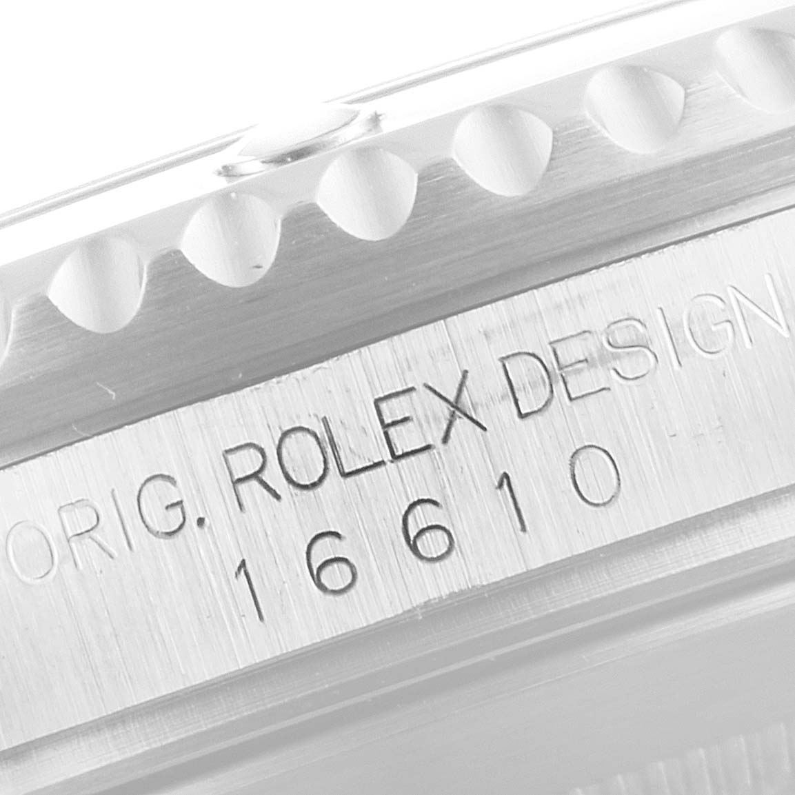 This close-up image shows the engraved model number and design mark on the side of a Rolex Submariner 16610 Men's Stainless Steel Black Dial 16610 Men's Stainless Steel Black Dial watch.