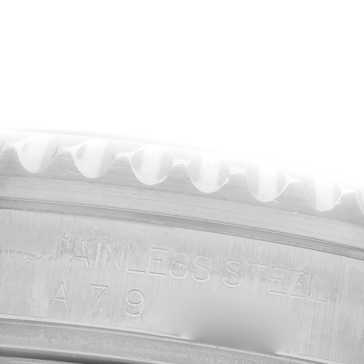 The image shows a close-up of the edge and engraving on the bezel of a Rolex Submariner 16610 Men's Stainless Steel Black Dial 16610 Men's Stainless Steel Black Dial watch.