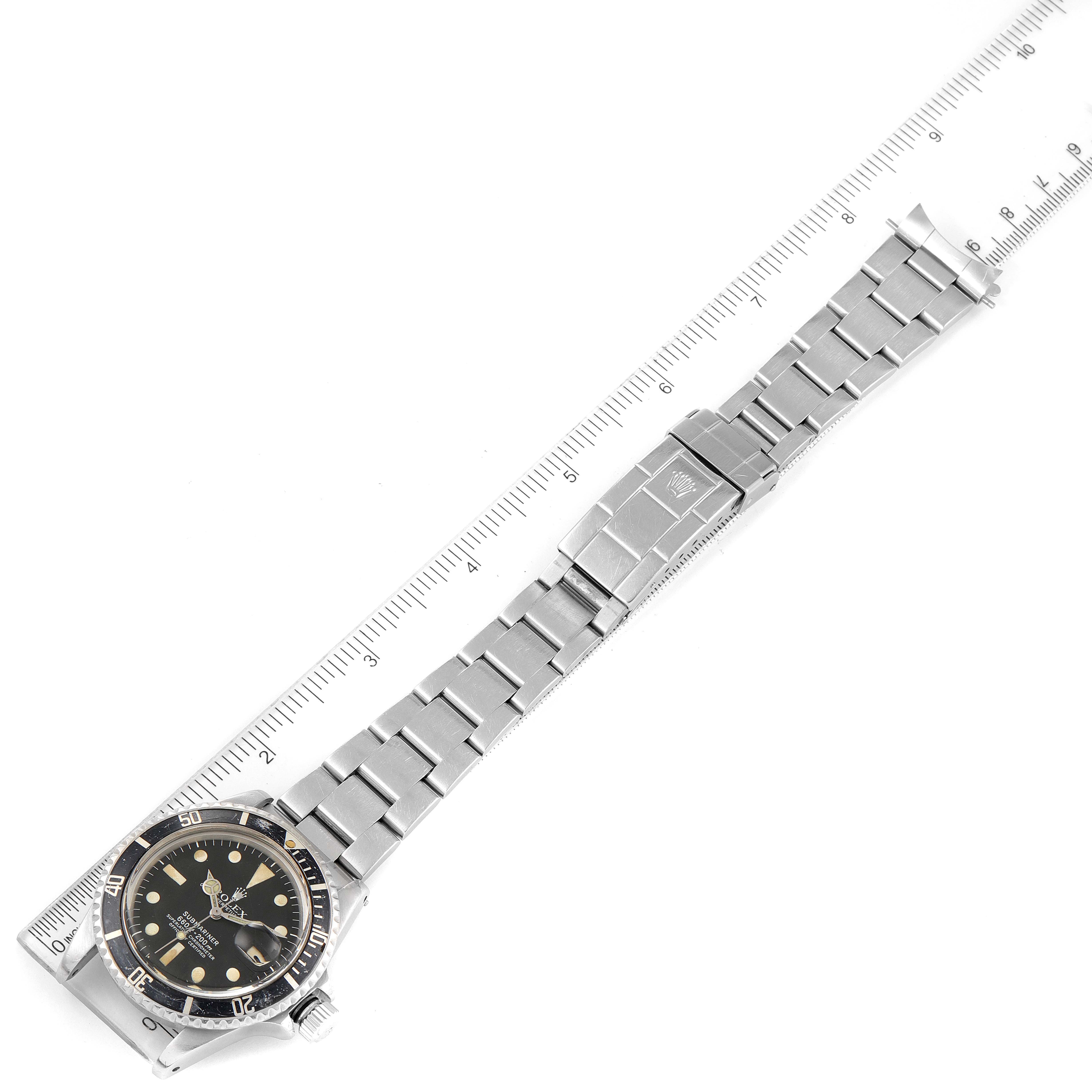 The image shows a Rolex Submariner 1680 Men's Stainless Steel Black Dial 1680 Men's Stainless Steel Black Dial watch laid flat, with the full bracelet and clasp visible, alongside a ruler for scale.
