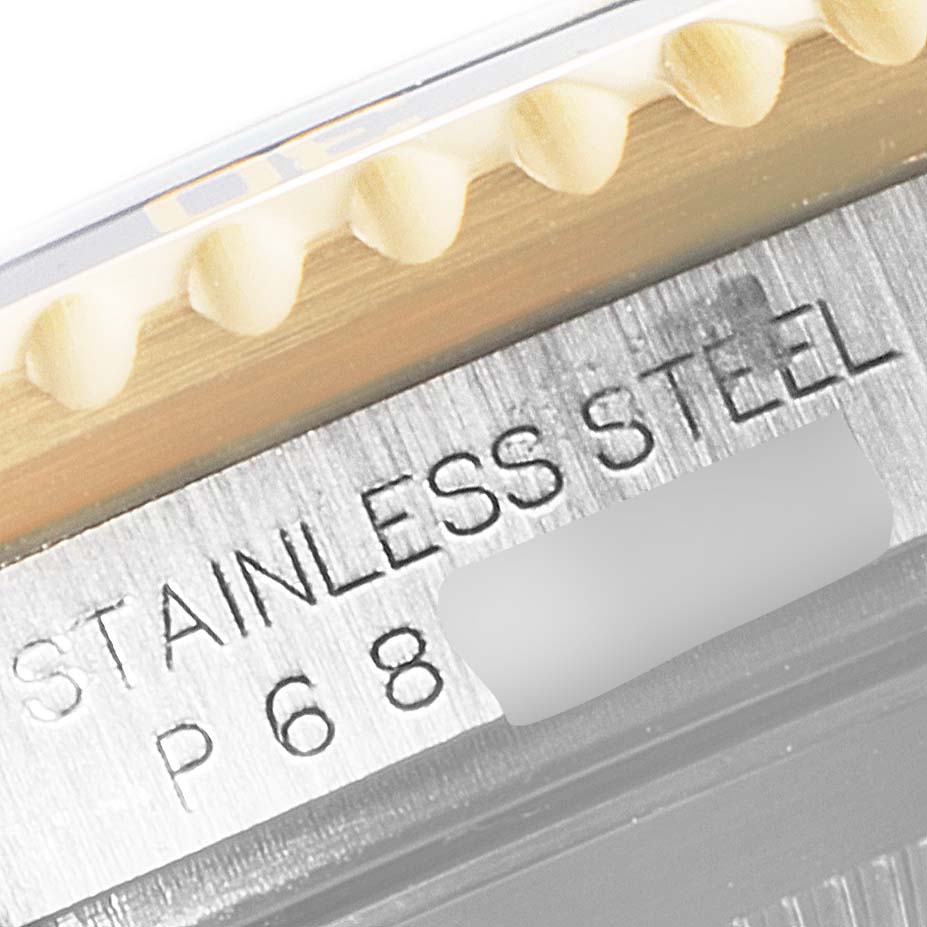 The image shows a close-up angle of the Rolex Submariner 16613 Men
s Steel and Gold (two tone) Blue Dial 16613 Men
s Steel and Gold (two tone) Blue Dial watch, focusing on the bezel teeth and the stainless steel engraving.