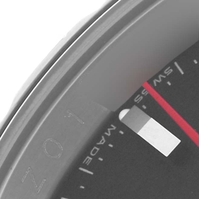 The image shows a close-up of the Rolex Turn-o-Graph 116264 Men's Stainless Steel Black Dial 116264 Men's Stainless Steel Black Dial model's bezel and part of the dial, including a marker and "SWISS MADE" text.