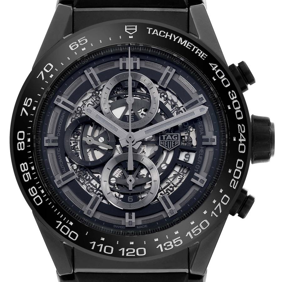 The Tag Heuer Carrera watch is shown from the front, highlighting its skeleton dial and tachymeter bezel.