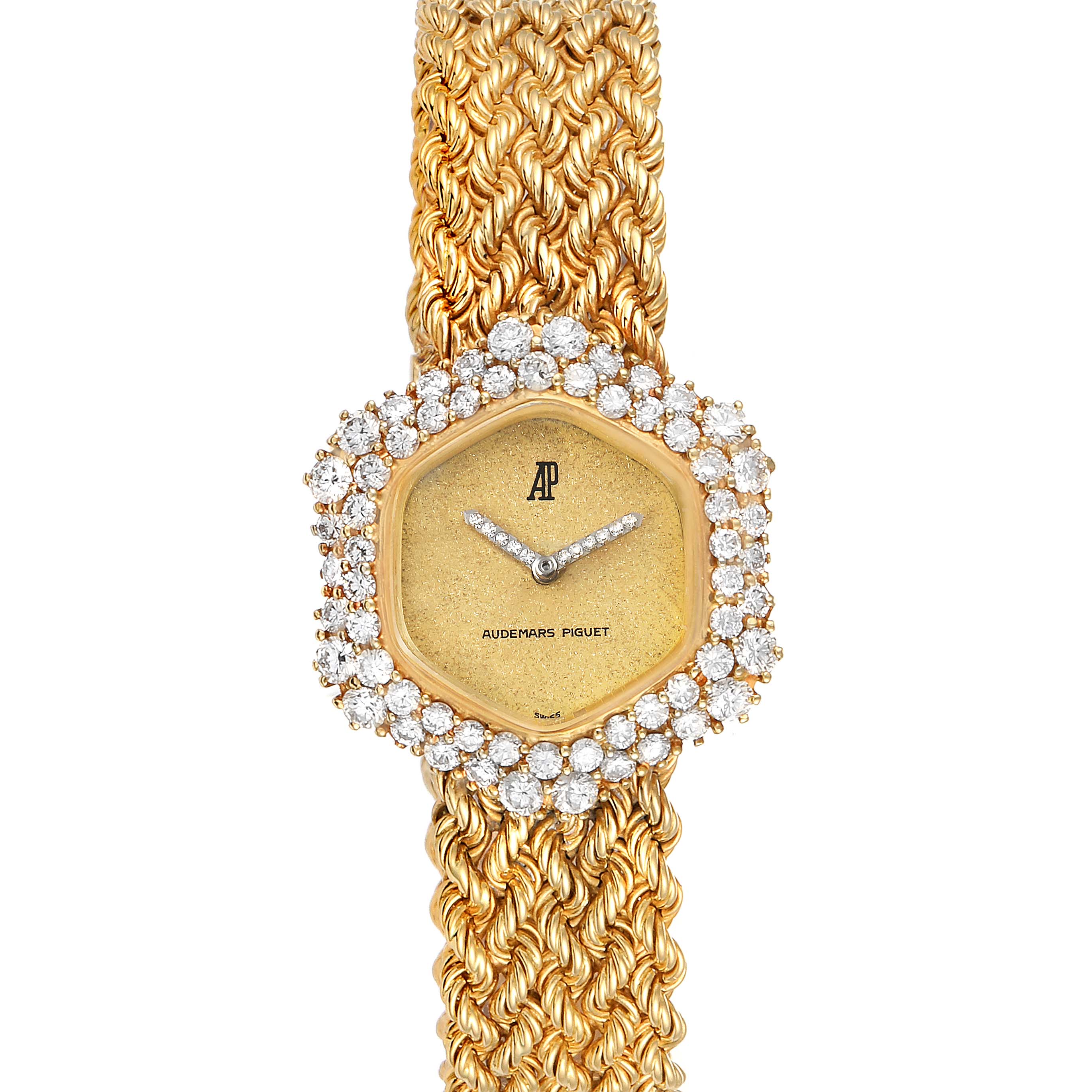 This image shows a close-up of a vintage Audemars Piguet watch, featuring a diamond-studded bezel and a gold braided strap.