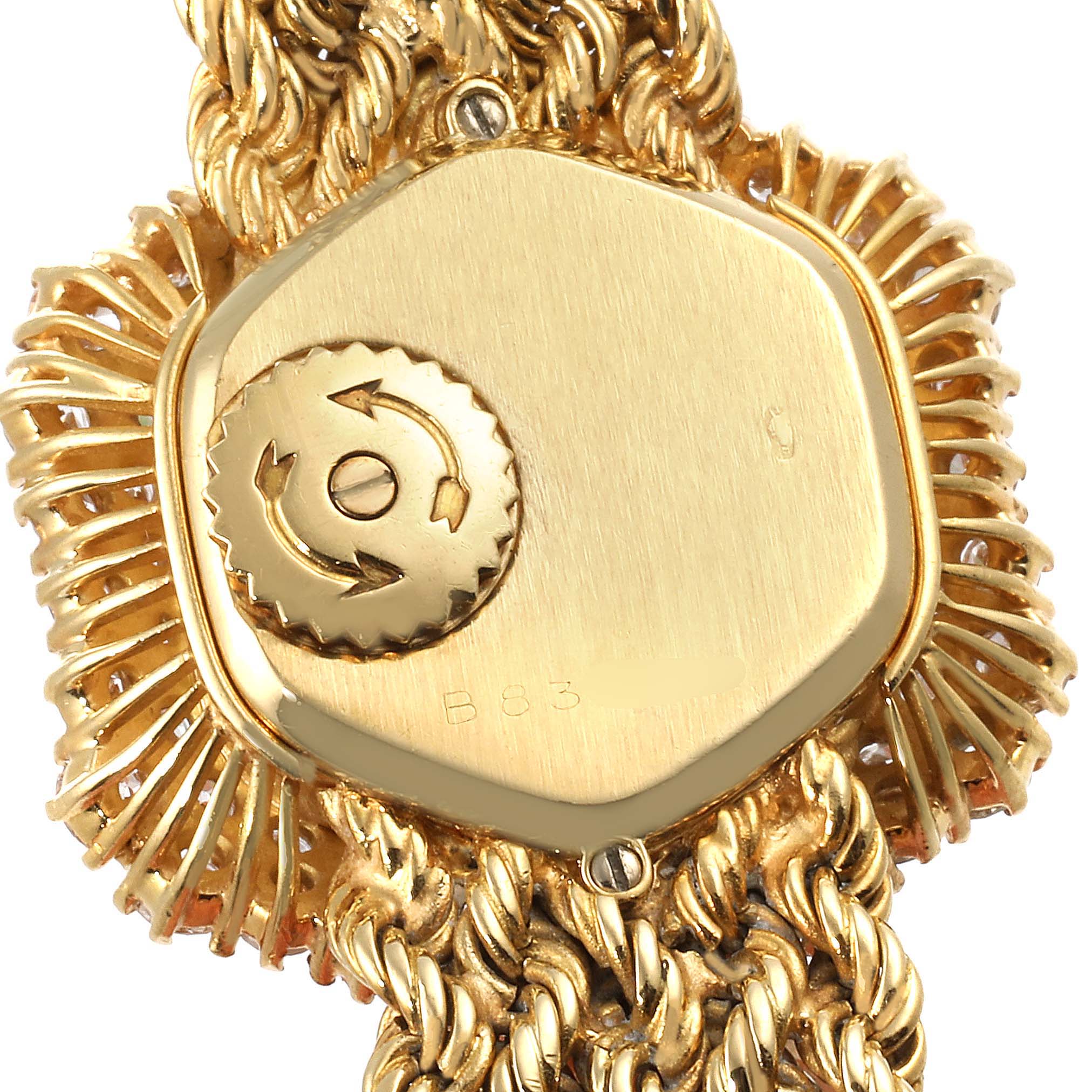 This close-up image shows the back case and part of the bracelet of a Vintage Audemars Piguet watch in gold.