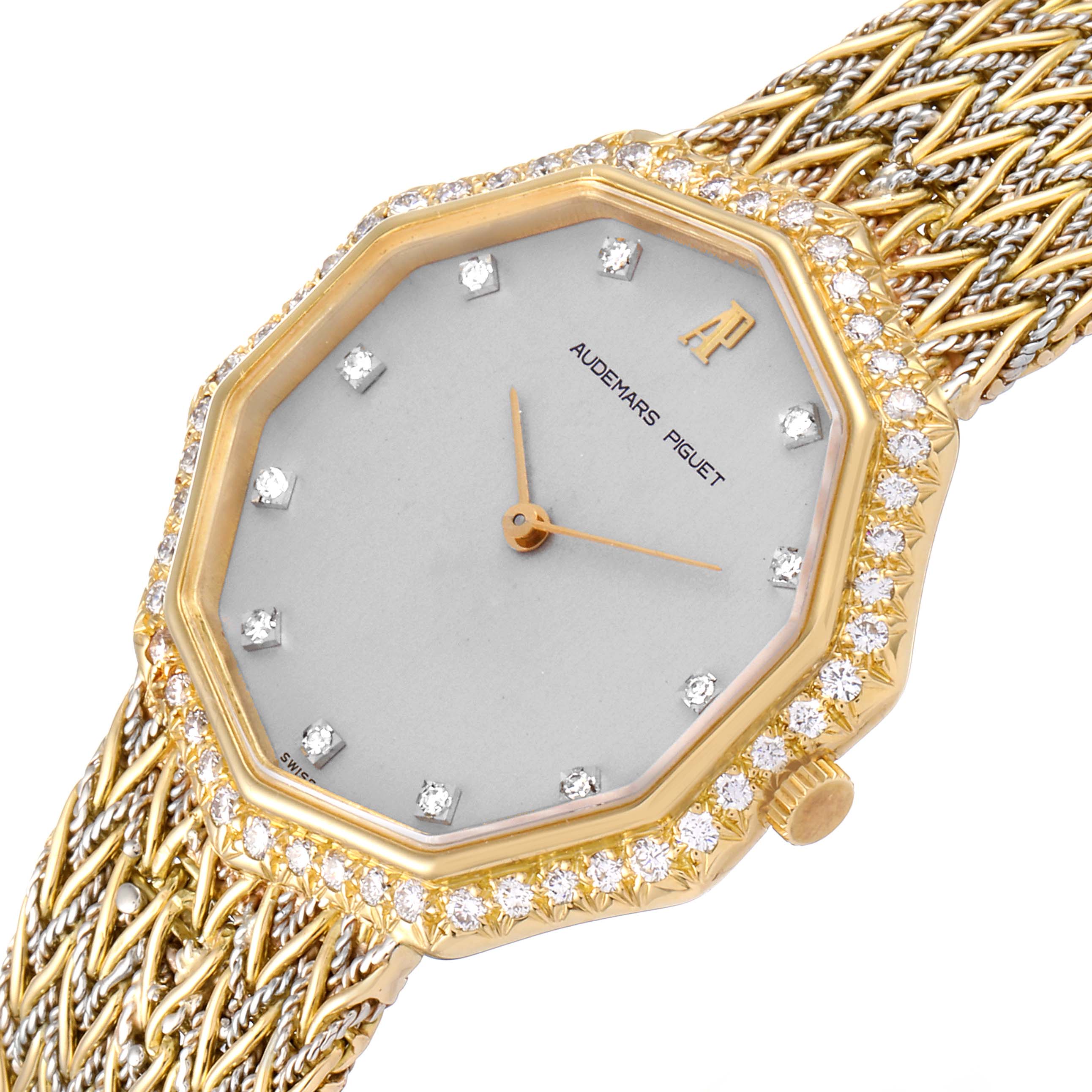The image shows a close-up view of a Vintage Audemars Piguet watch, highlighting the face, diamond bezel, and part of the woven strap.