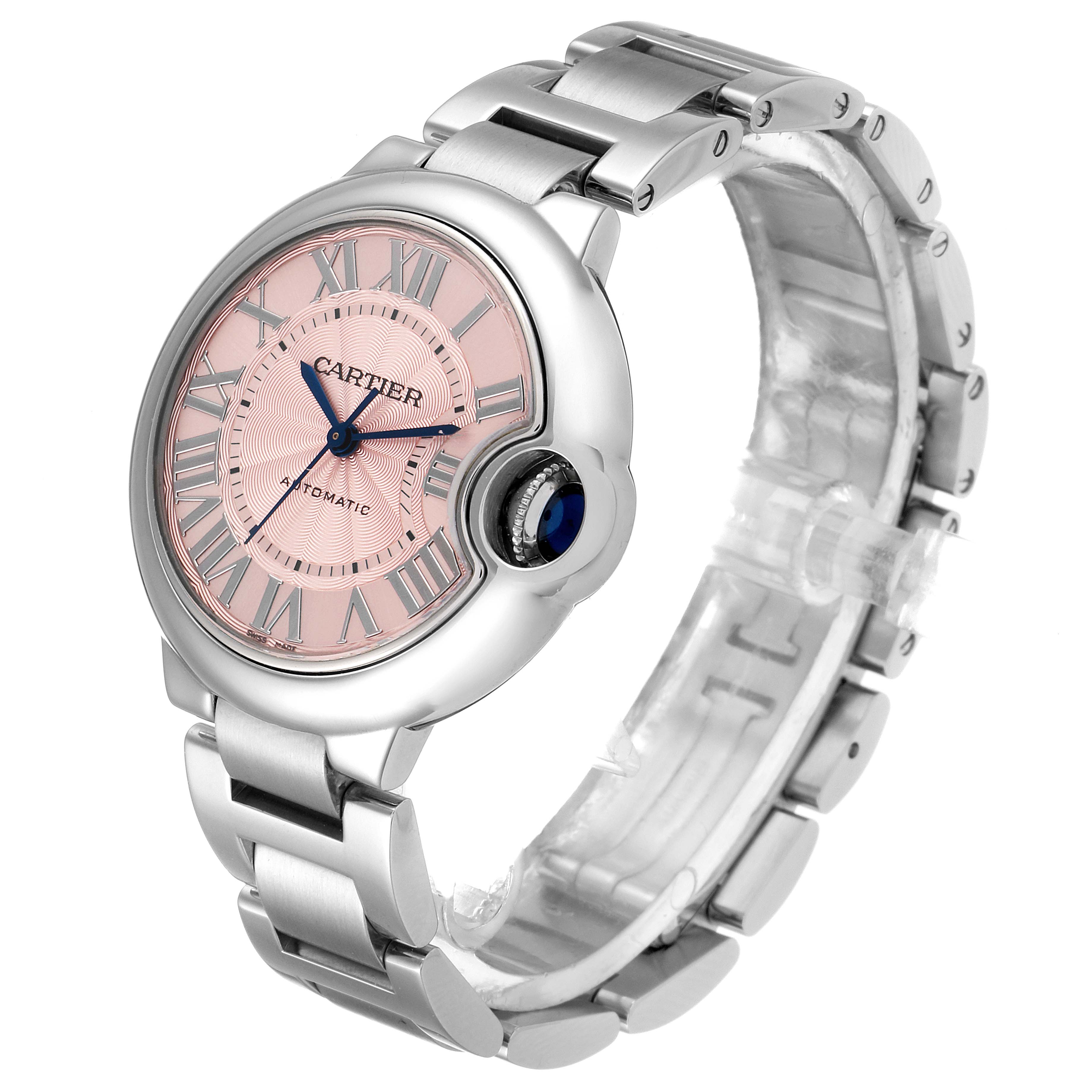 This image shows a Cartier Ballon Bleu W6920100 Women
s Stainless Steel Pink Dial W6920100 Women
s Stainless Steel Pink Dial watch from an angled overhead view, highlighting its pink dial, crown, and bracelet.