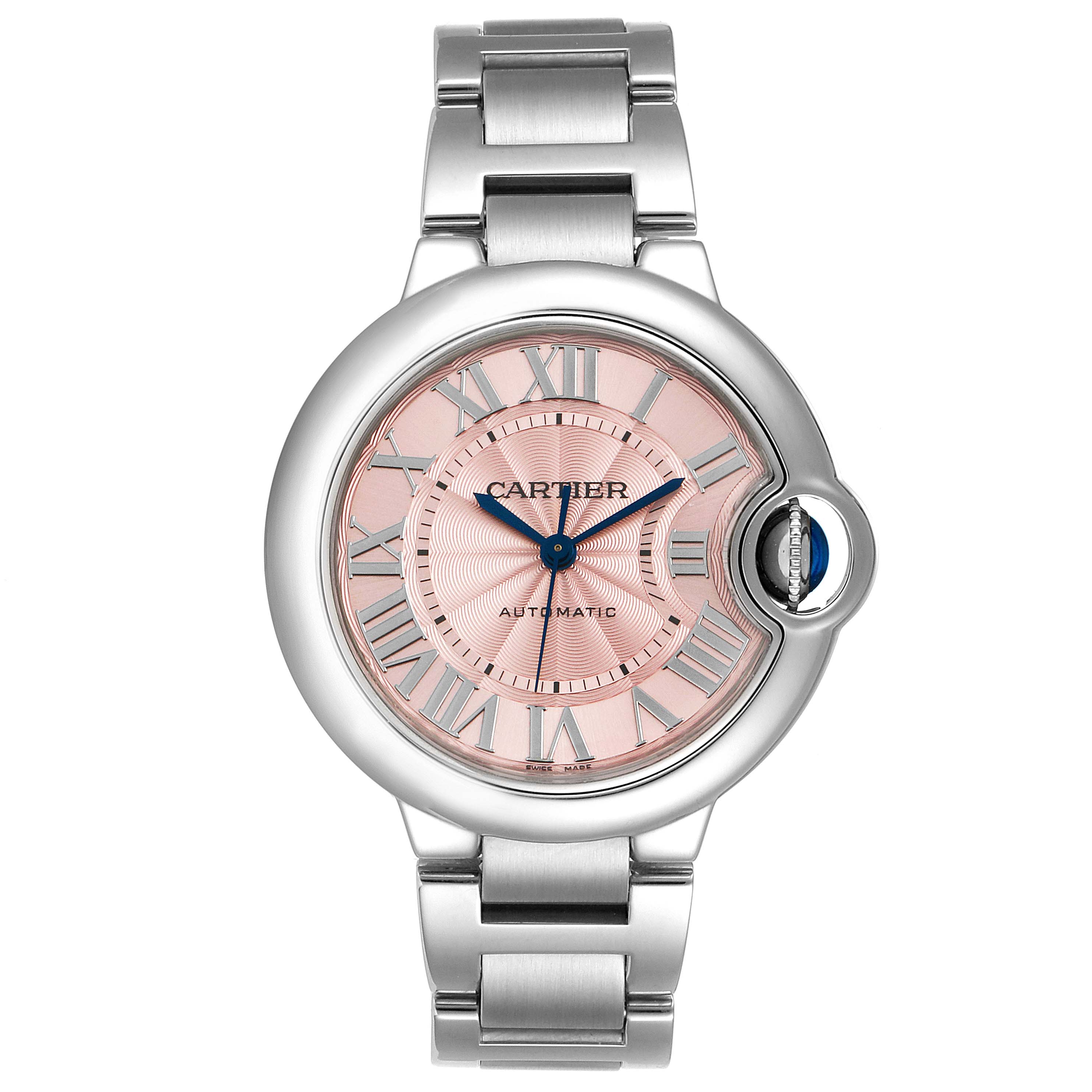 The image shows a front view of a Cartier Ballon Bleu W6920100 Women
s Stainless Steel Pink Dial W6920100 Women
s Stainless Steel Pink Dial watch with a pink dial, Roman numerals, and a silver bracelet.