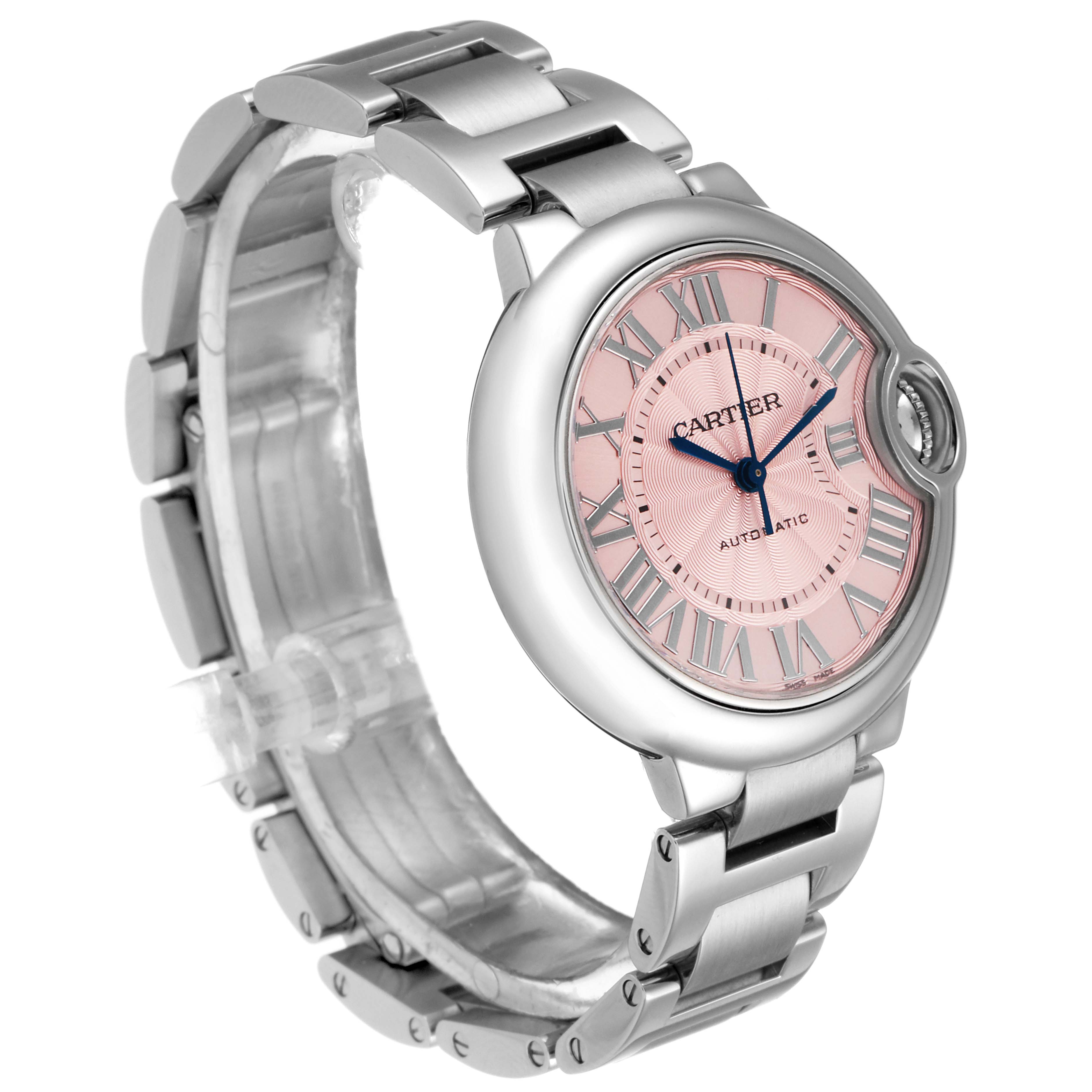 This is a side view of the Cartier Ballon Bleu W6920100 Women
s Stainless Steel Pink Dial W6920100 Women
s Stainless Steel Pink Dial watch, showing the pink dial, Roman numeral markers, blue hands, and metal bracelet.