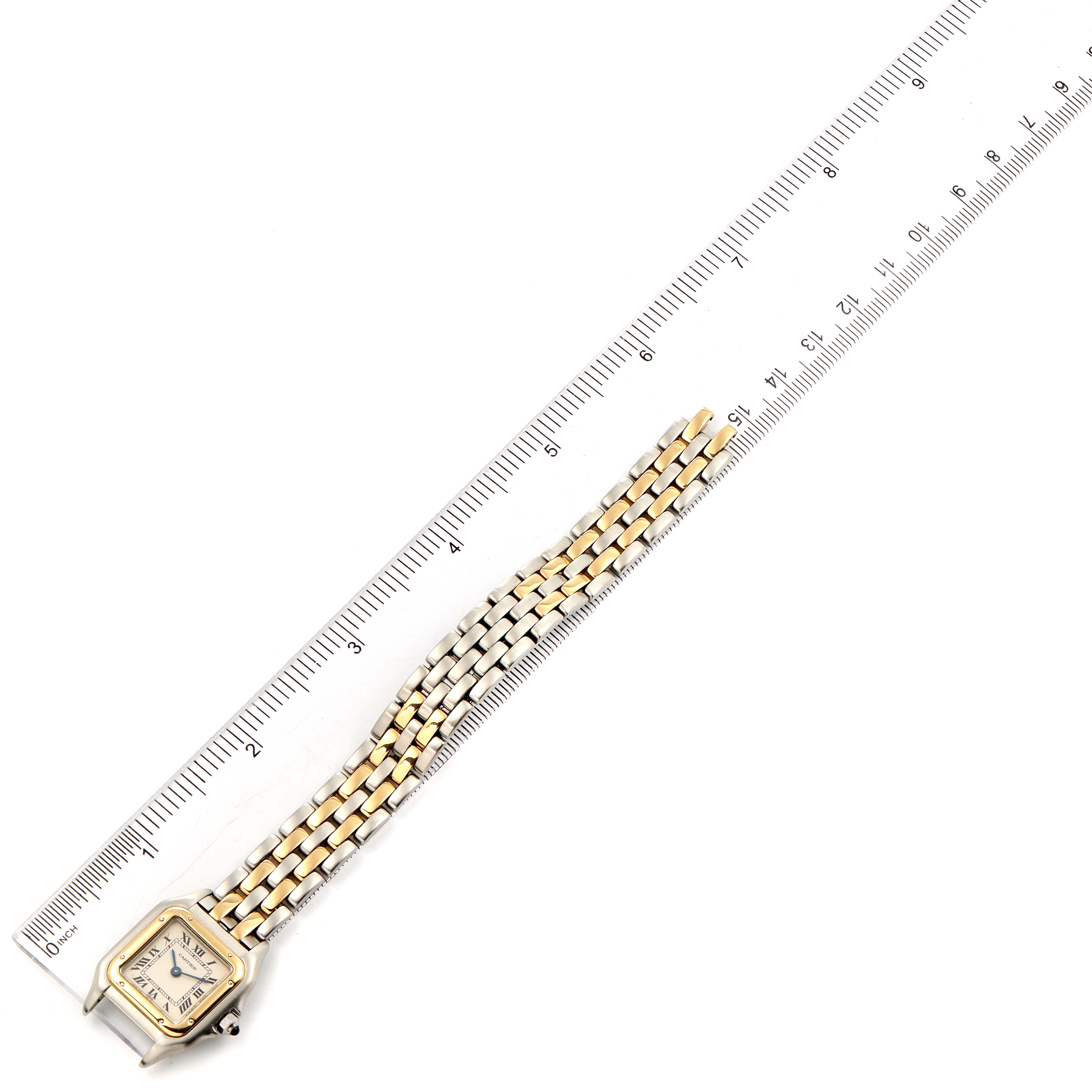 The image shows a top view of the Panthere model watch by Cartier, including the face and bracelet, placed next to a ruler.