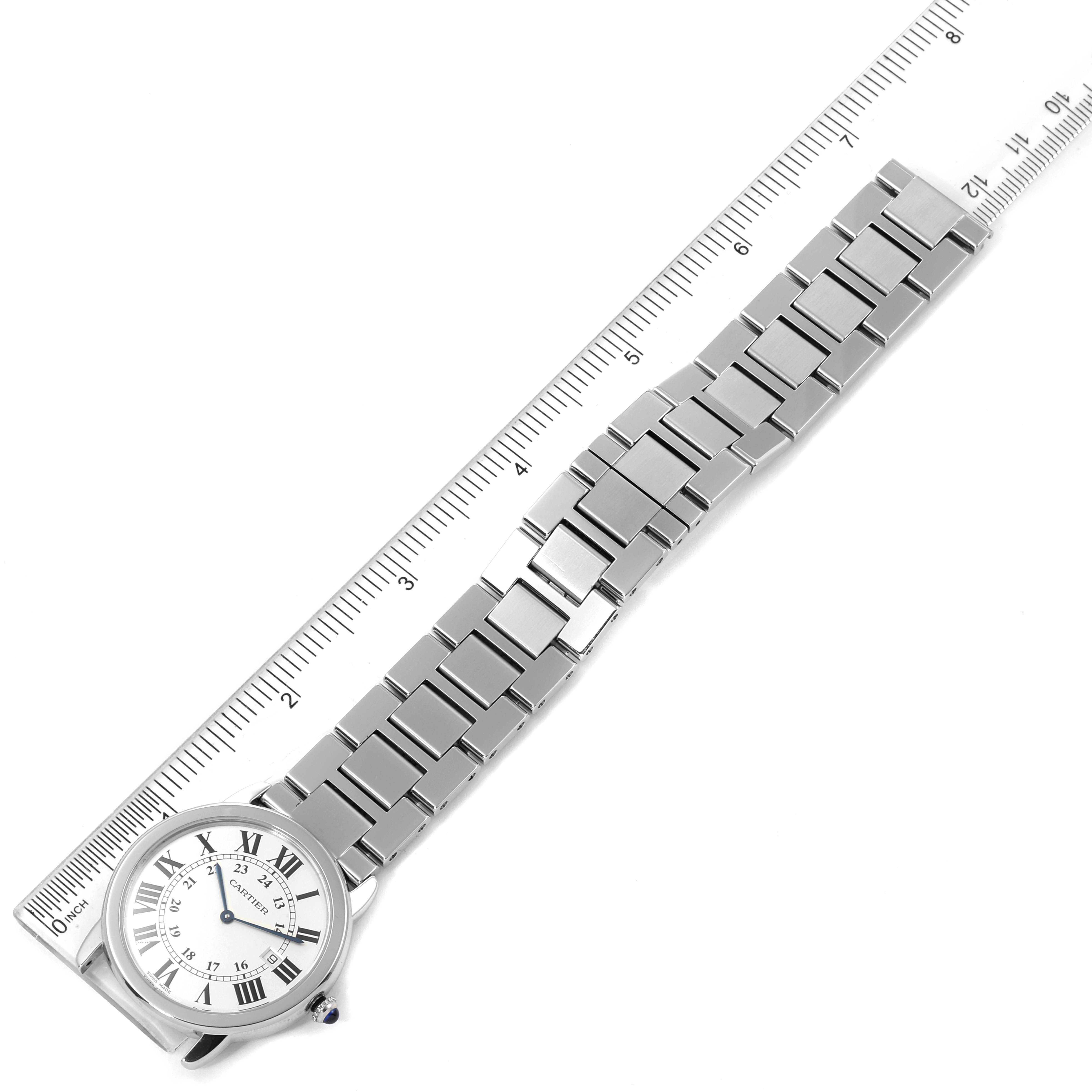 The image shows an overhead view of a Cartier Ronde W6701005 Men
s Stainless Steel Silver Dial W6701005 Men
s Stainless Steel Silver Dial model watch next to a ruler for scale.