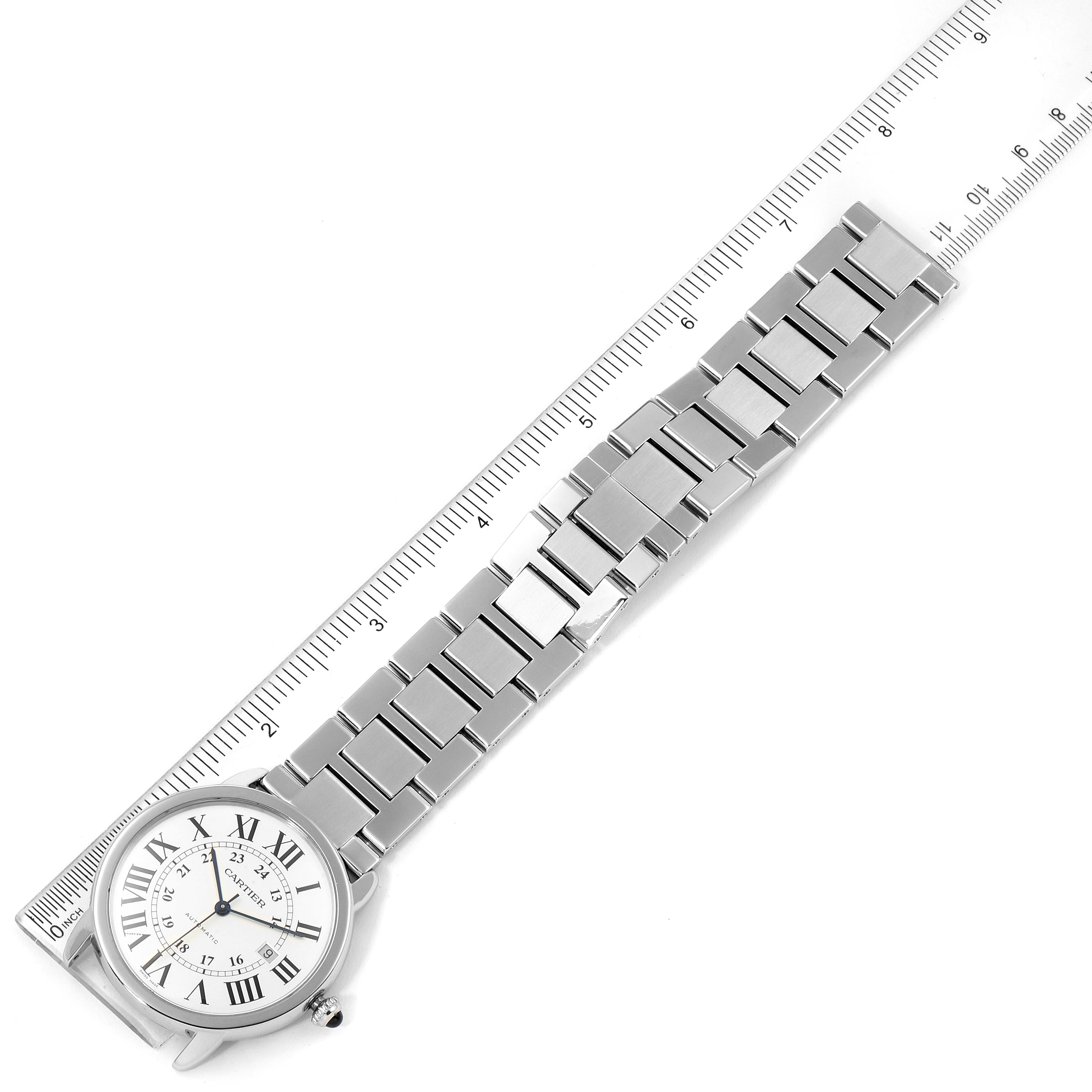The image shows a top-down view of a Cartier Ronde W6701011 Men
s Stainless Steel Silver Dial W6701011 Men
s Stainless Steel Silver Dial watch with its metal bracelet and a ruler for scale.