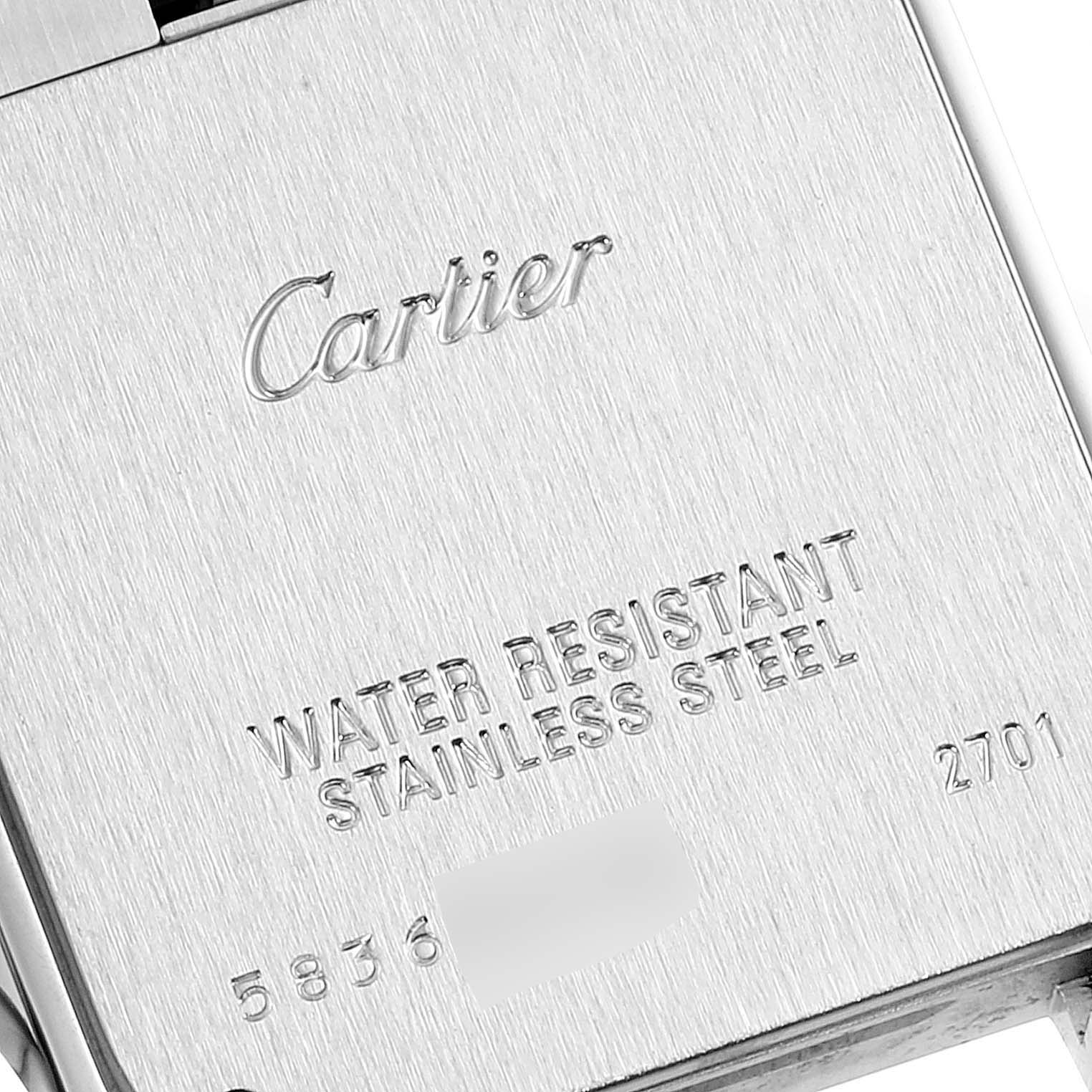 The image shows the case back of the Santos model by Cartier, highlighting the brand logo and engraved specifications.