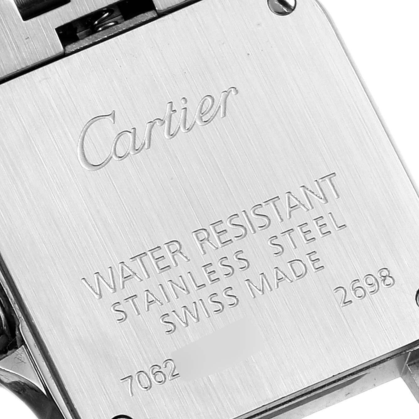 The image shows the back case of a Cartier Santos Demoiselle W25066Z6 Women
s Steel and Gold (two tone) Silver Dial W25066Z6 Women
s Steel and Gold (two tone) Silver Dial watch with engraved details.