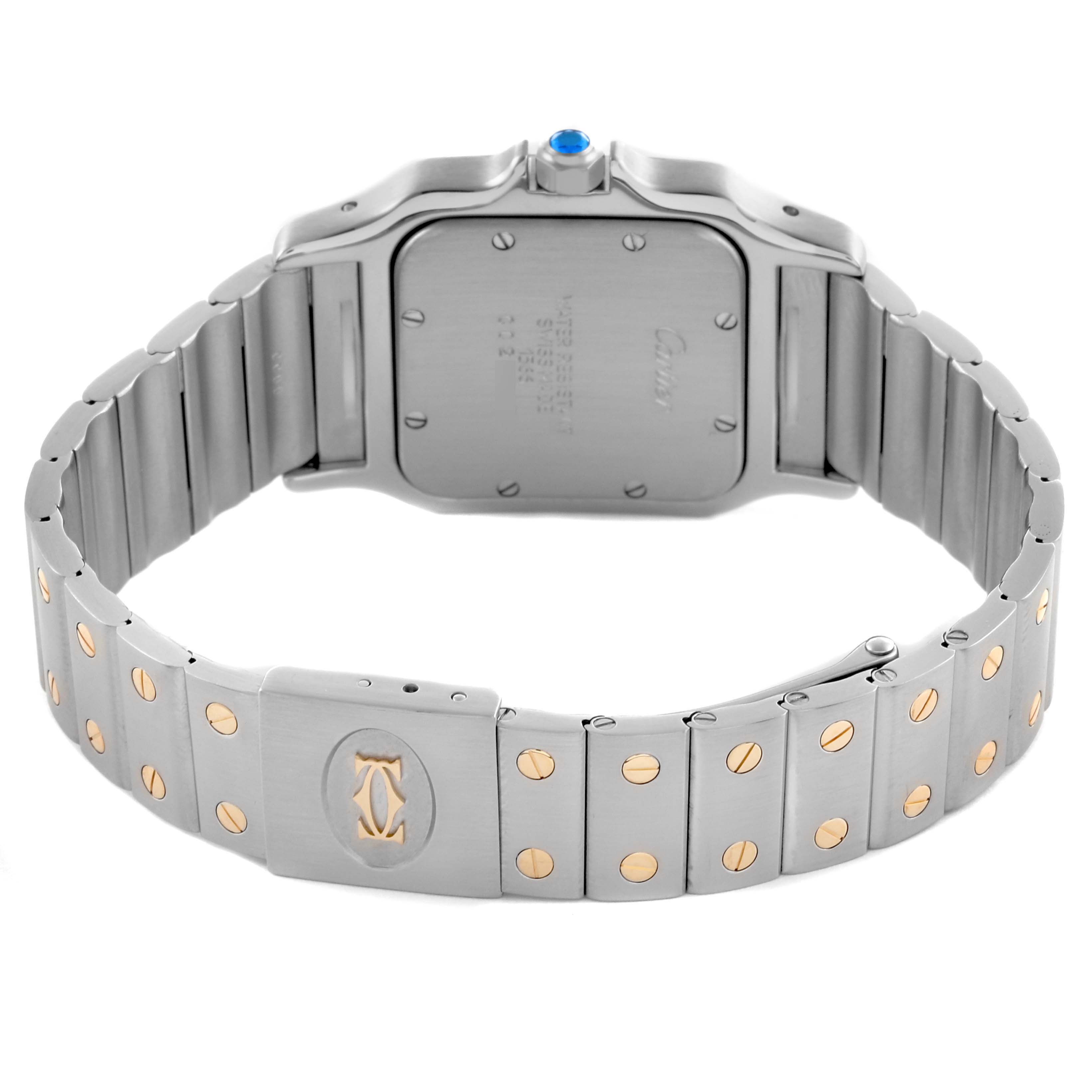 The image shows the back case and bracelet of a Santos model by Cartier, highlighting the clasp and dual-tone metal links.