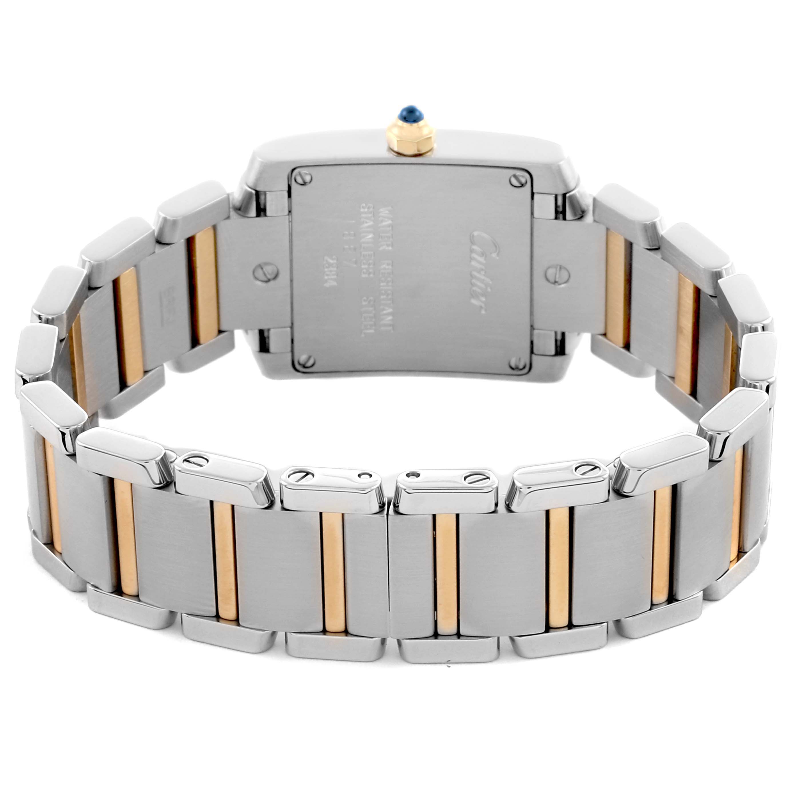 The image shows the back view of a Cartier Tank Française watch, highlighting the stainless steel and gold bracelet and case back.