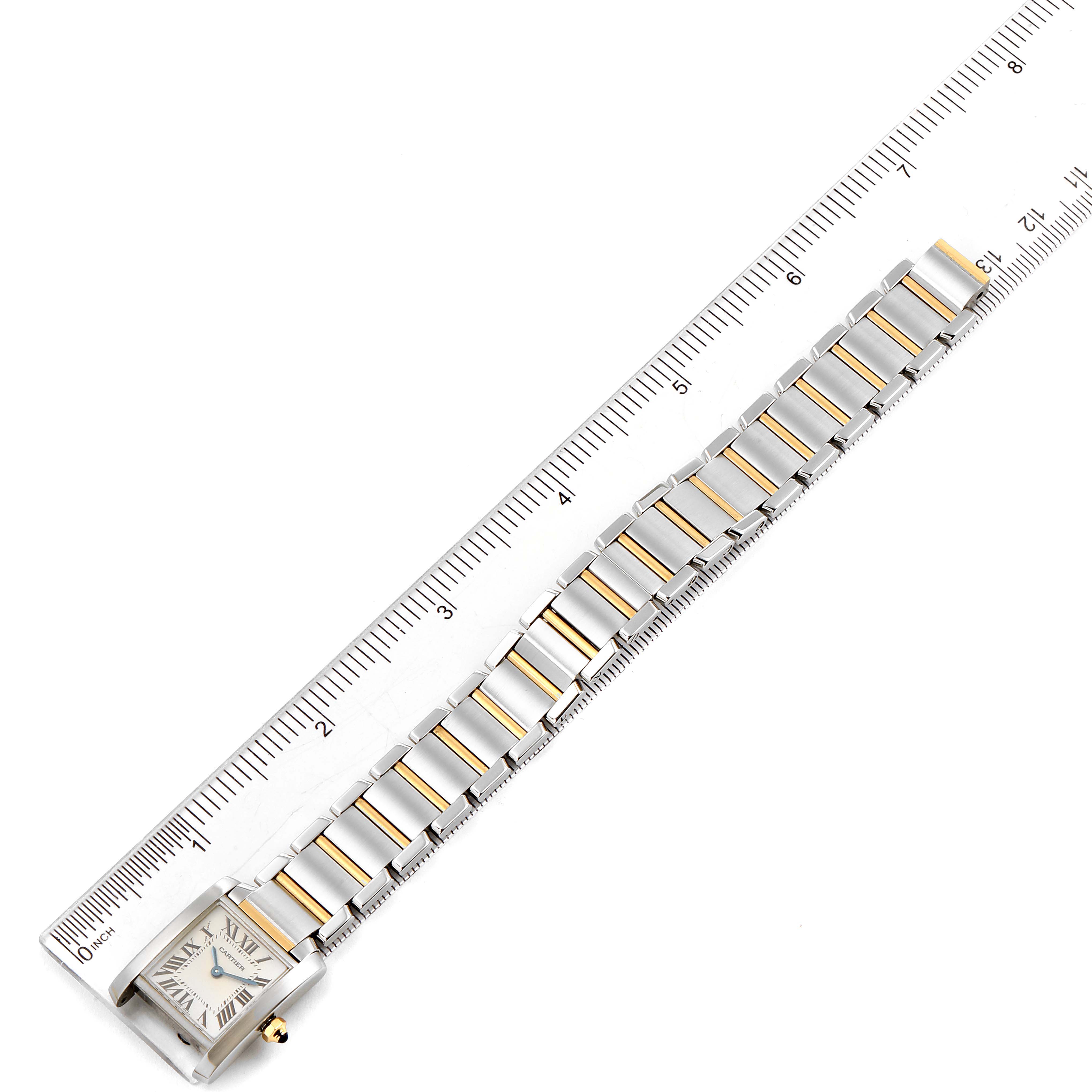 The image shows a Cartier Tank Francaise W51007Q4 Women's Steel and Gold (two tone) Silver Dial W51007Q4 Women's Steel and Gold (two tone) Silver Dial watch laid flat next to a ruler for measurement.