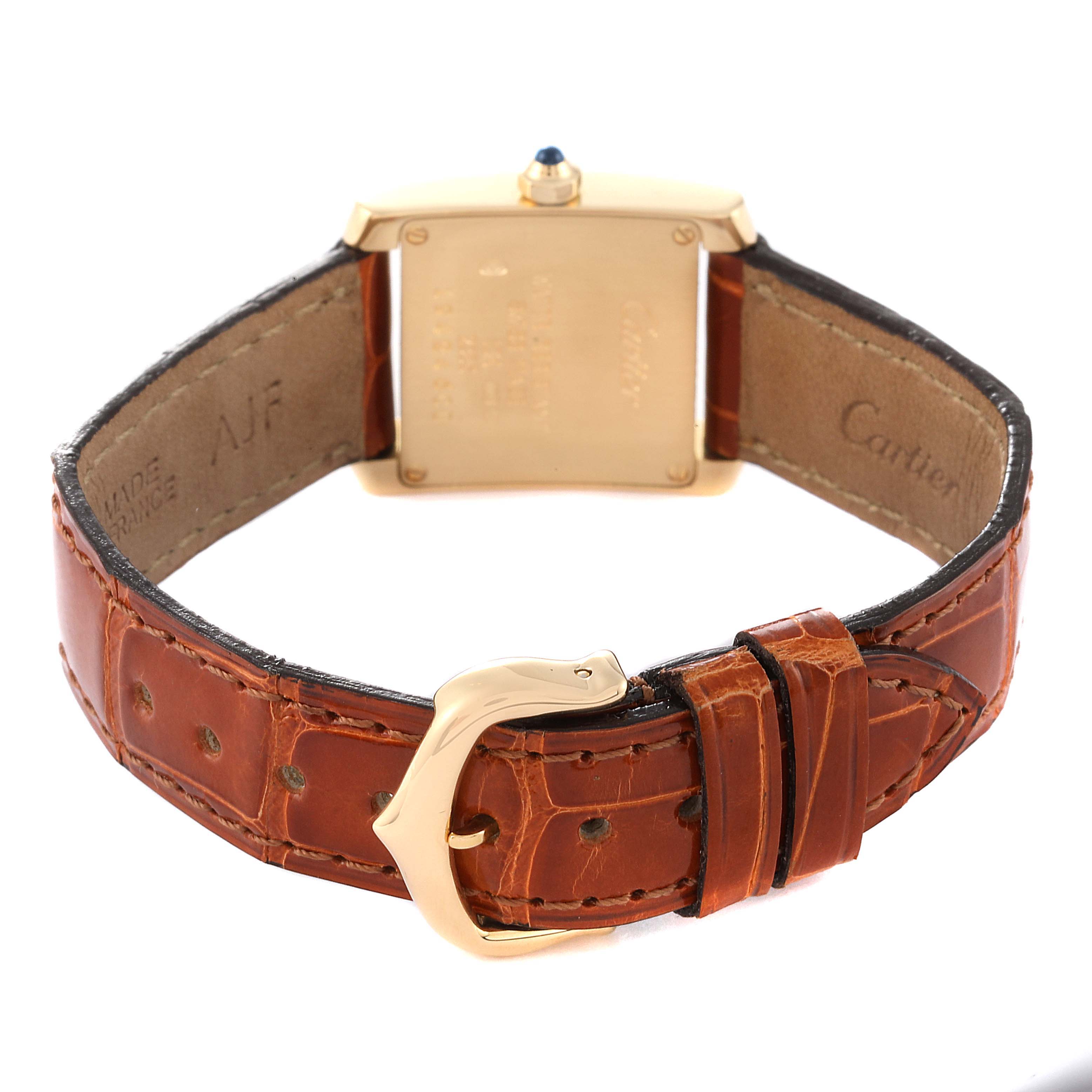 The image shows the back of a Cartier Tank Francaise W5000256 Women's Yellow Gold Silver Dial W5000256 Women's Yellow Gold Silver Dial watch with a brown leather strap and a gold buckle.