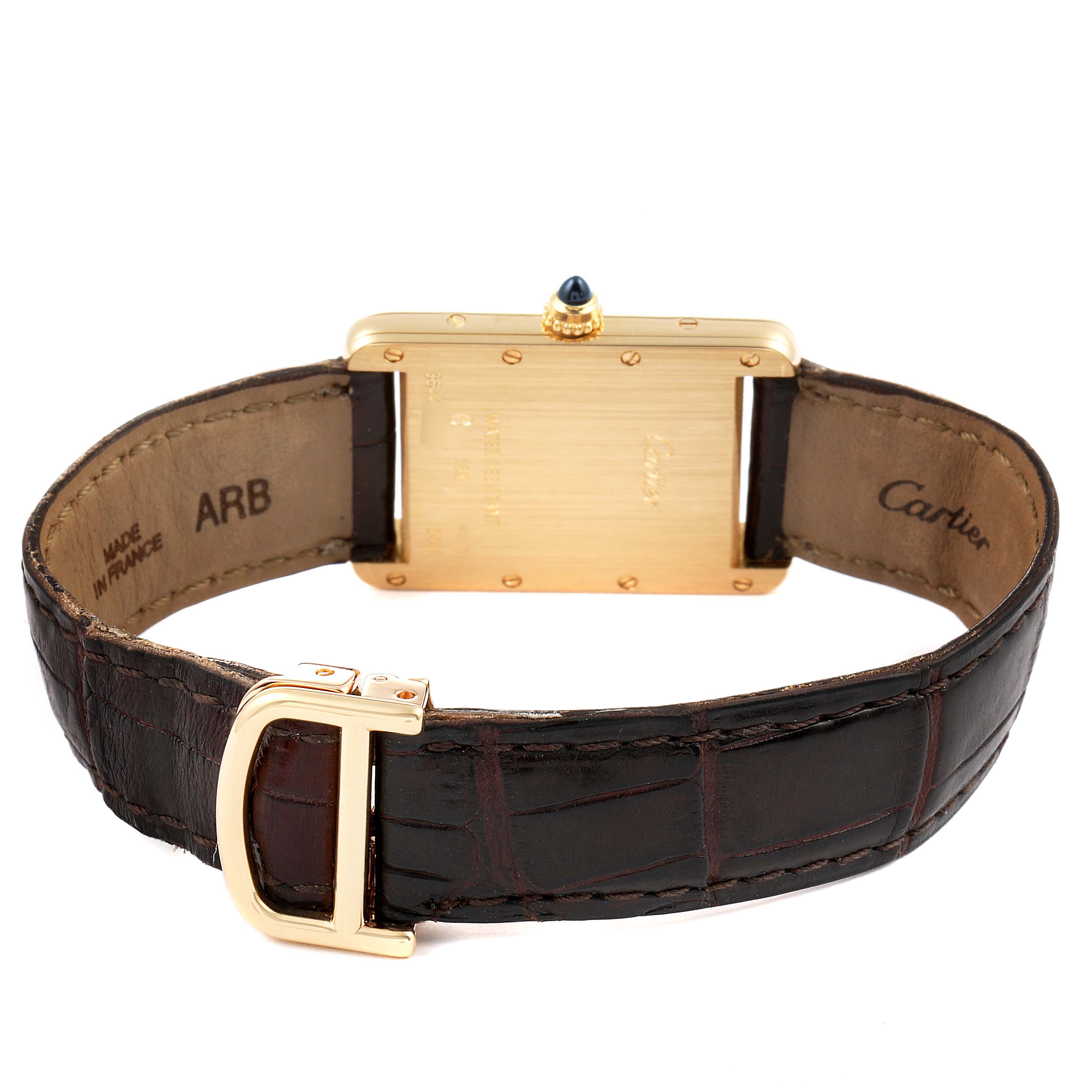 This image shows the back and clasp of the Cartier Tank Louis W1529756 Men's Yellow Gold Silver Dial W1529756 Men's Yellow Gold Silver Dial watch with a leather strap.