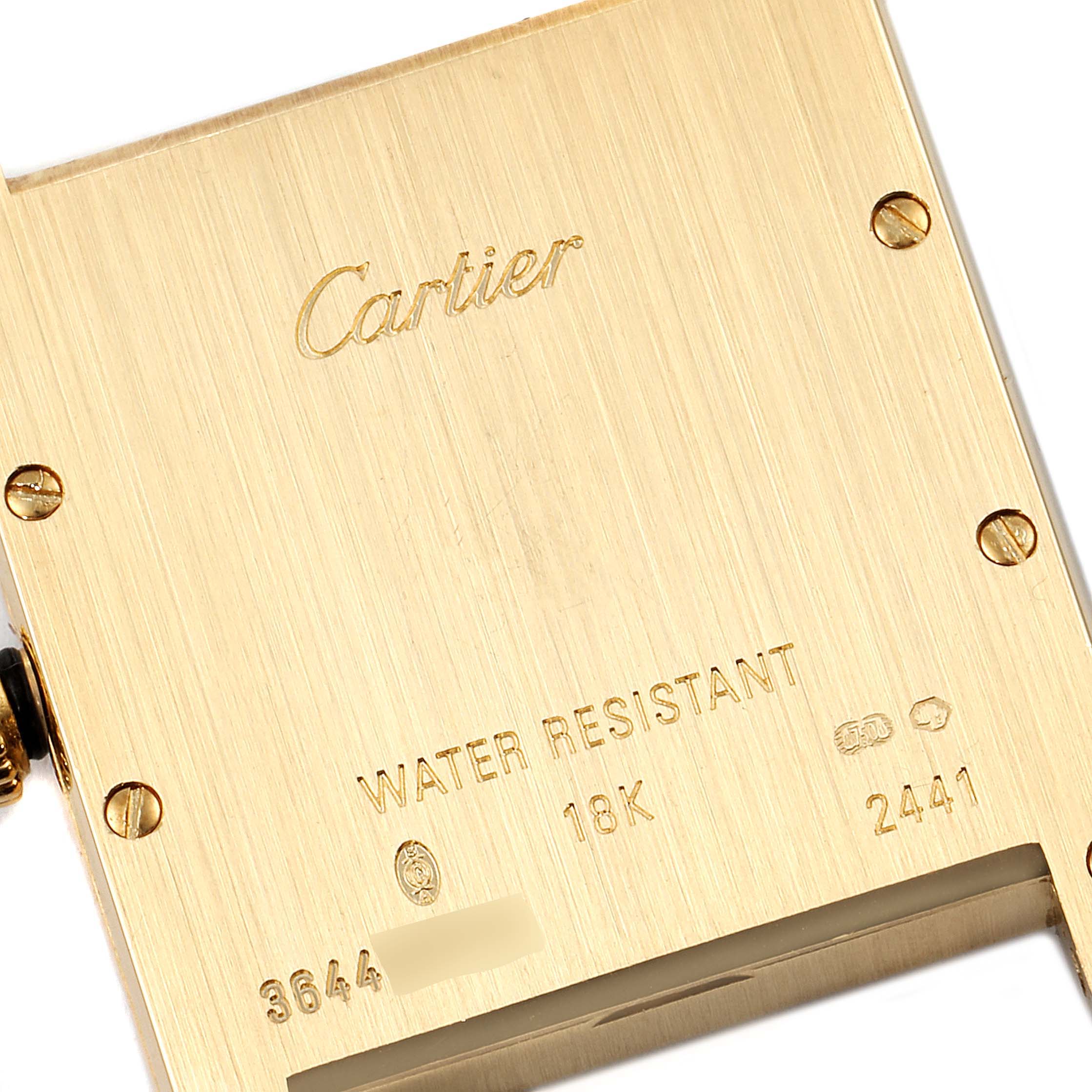 The image shows the back case of a Cartier Tank Louis W1529756 Men's Yellow Gold Silver Dial W1529756 Men's Yellow Gold Silver Dial watch, highlighting its engravings and screws.