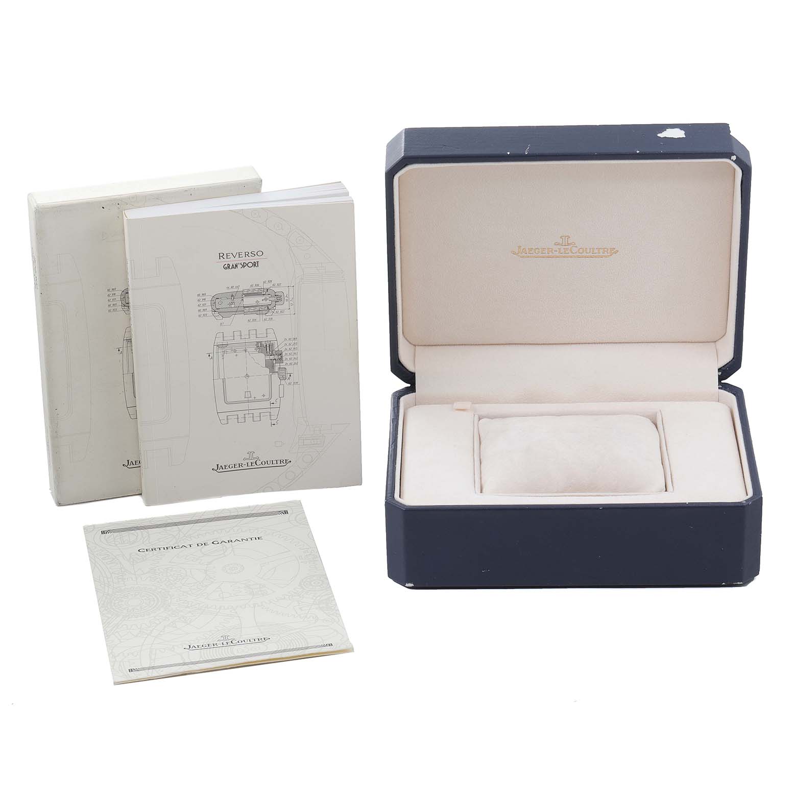 This image shows the packaging, manuals, and certificate of guarantee for a Jaeger-LeCoultre Reverso watch.