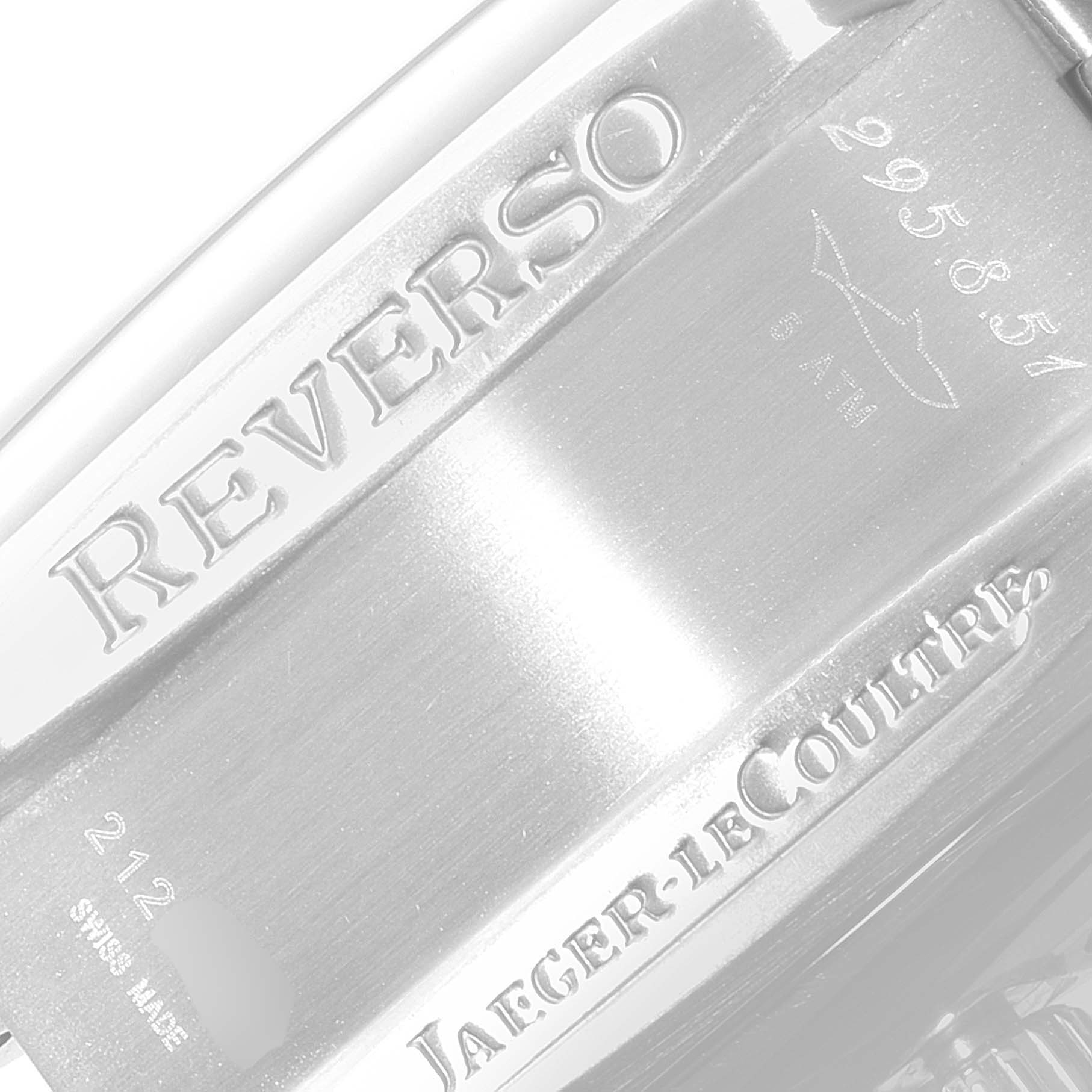 This image shows a close-up of the backplate of a Jaeger-LeCoultre Reverso watch with engraved text and serial numbers.