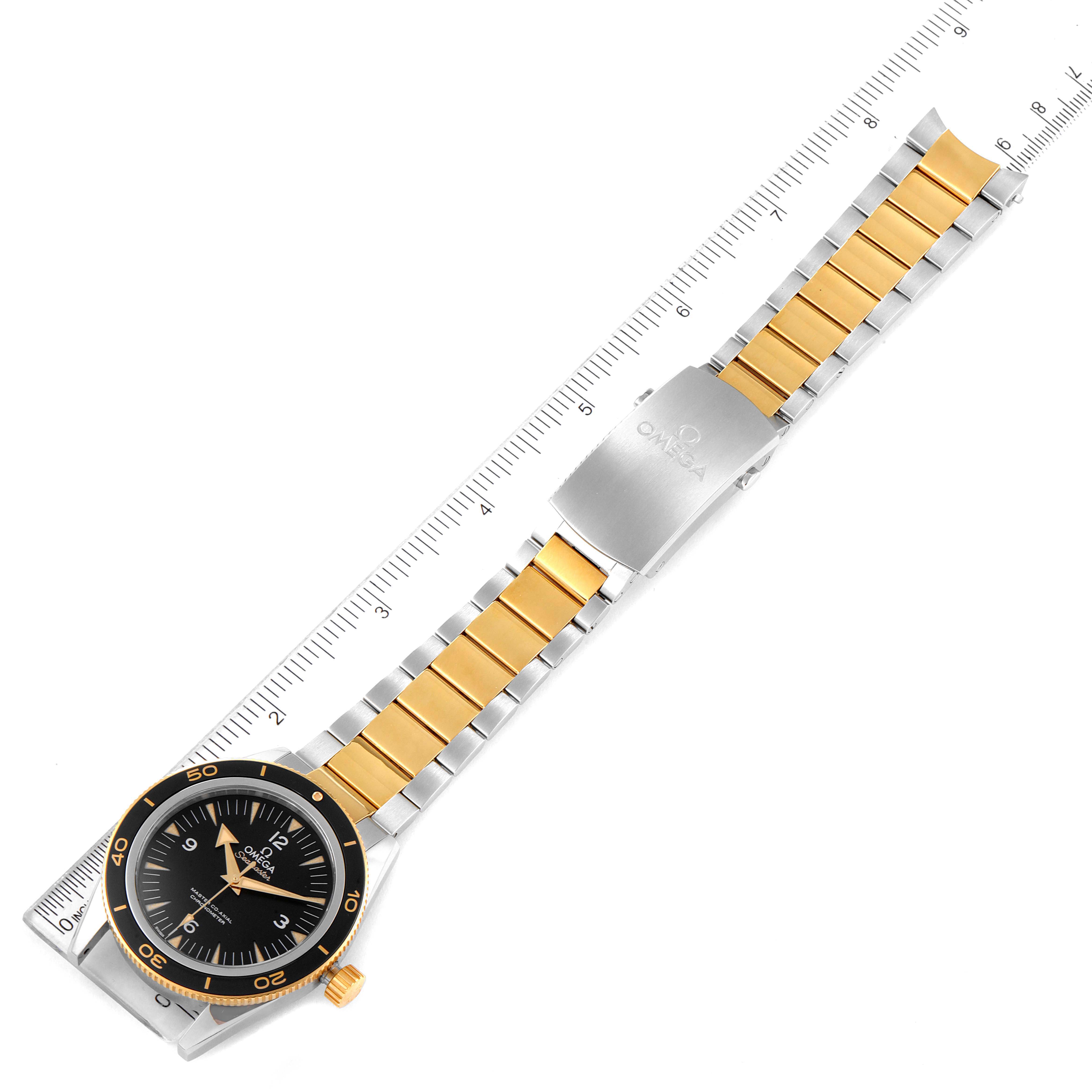 The image shows an Omega Seamaster 233.20.41.21.01.001 Men's Steel and Gold (two tone) Black Dial 233.20.41.21.01.001 Men's Steel and Gold (two tone) Black Dial watch laid flat with the dial facing up and a measuring ruler beside it.