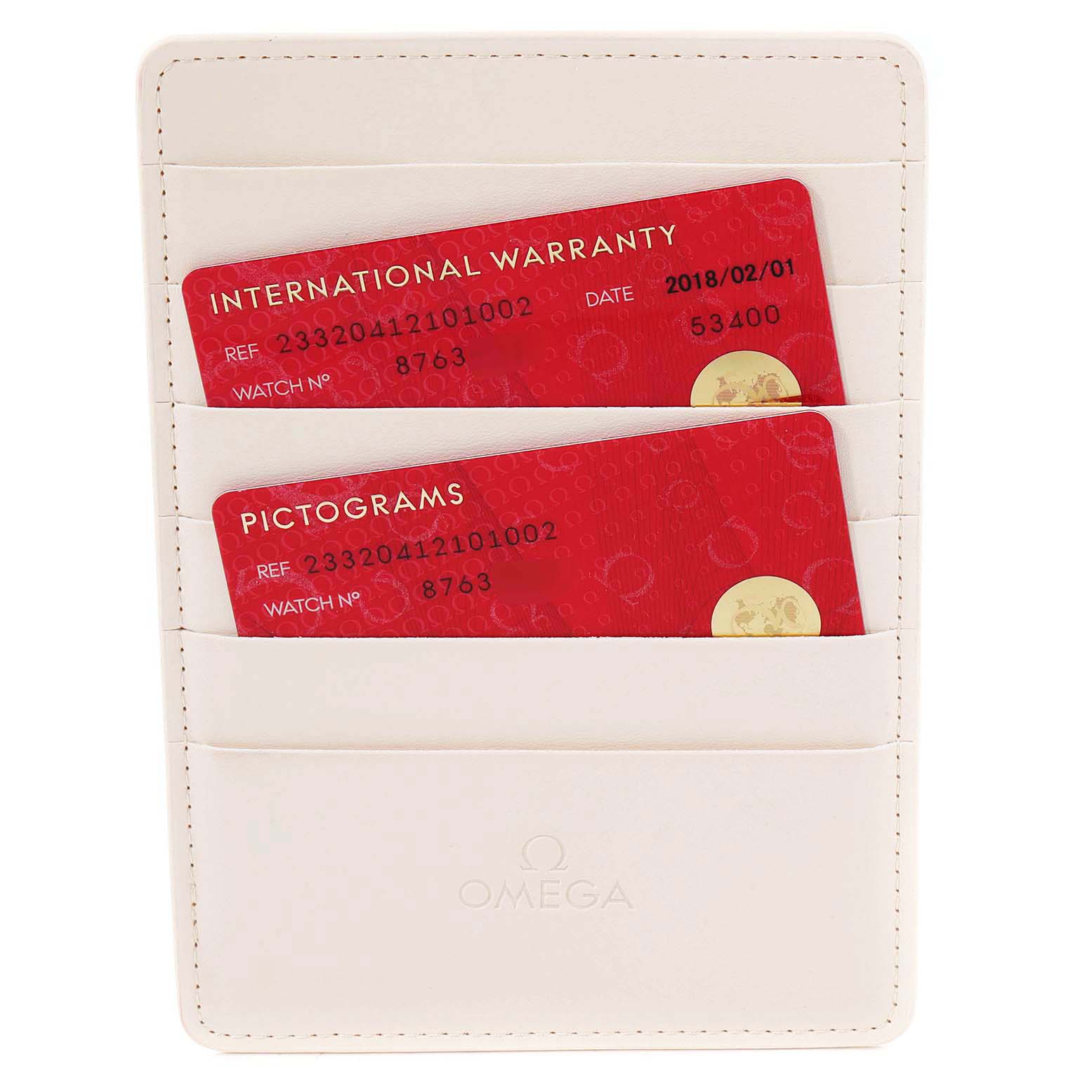The image shows warranty and pictogram cards for the Seamaster model by Omega in a white cardholder.