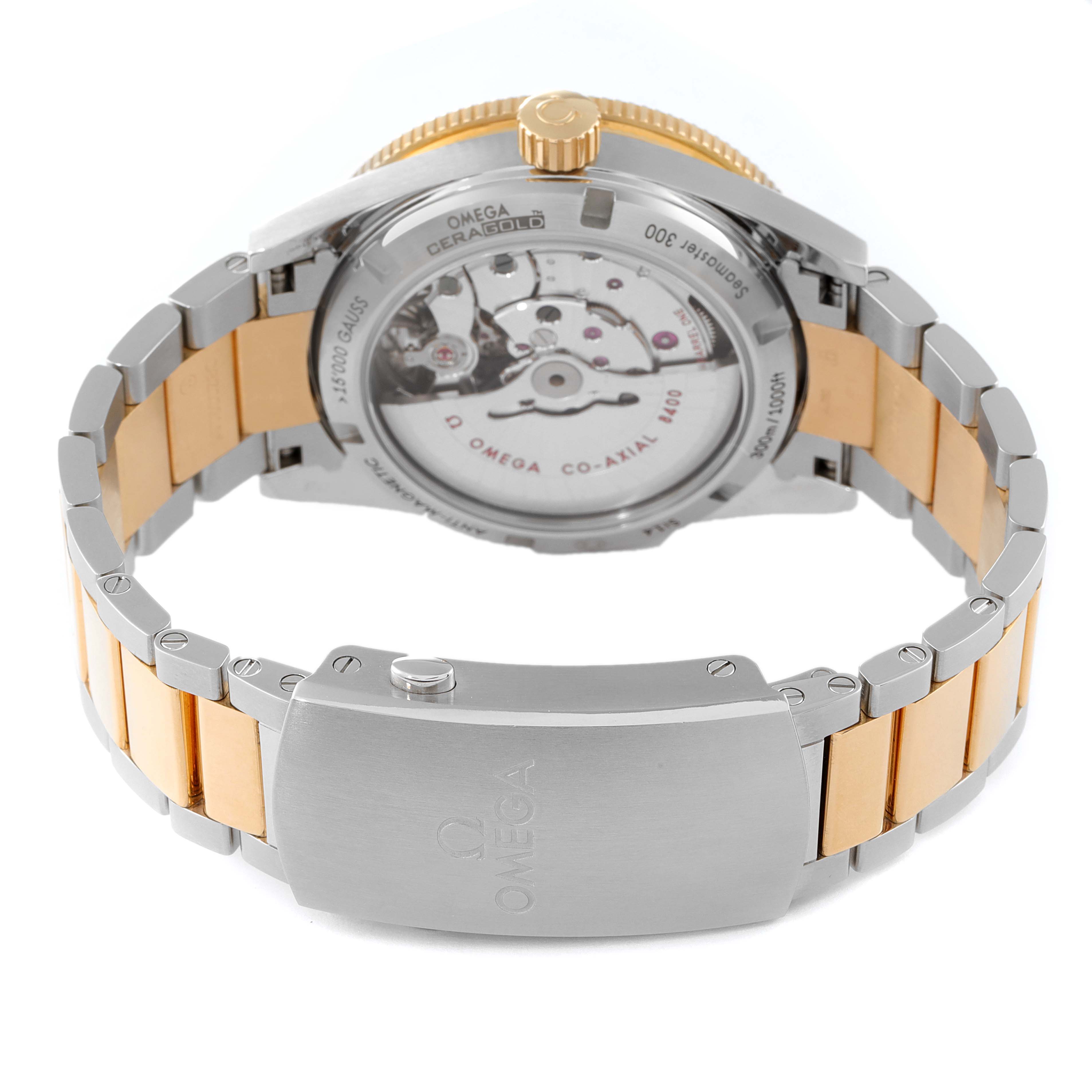 The image shows the back view of an Omega Seamaster 233.20.41.21.01.001 Men's Steel and Gold (two tone) Black Dial 233.20.41.21.01.001 Men's Steel and Gold (two tone) Black Dial watch, highlighting its movement and the bracelet clasp.