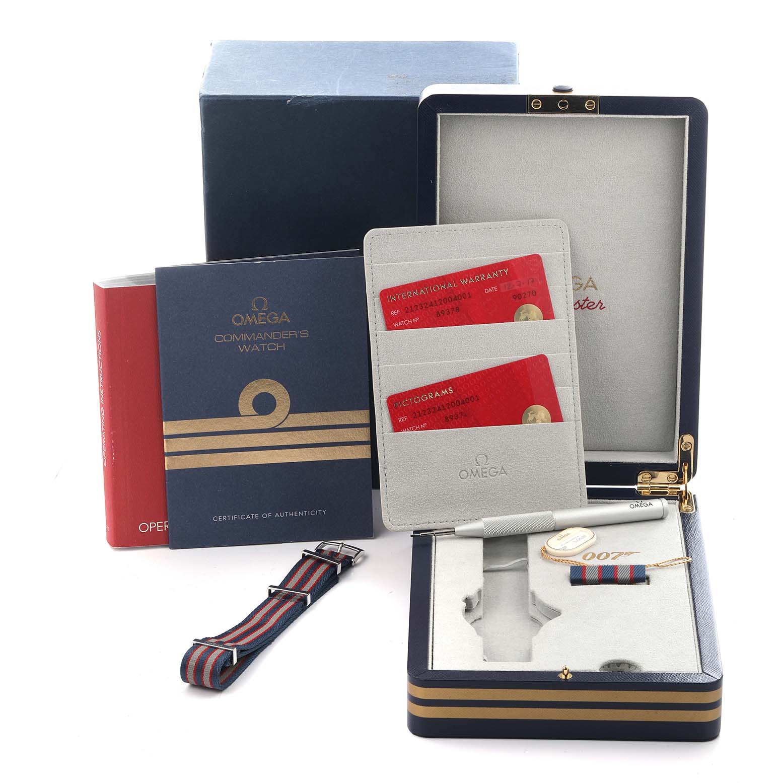 The image shows packaging and accessories for the Omega Seamaster 212.32.41.20.04.001 Men's Stainless Steel White Dial 212.32.41.20.04.001 Men's Stainless Steel White Dial, including a box, warranty cards, a strap, and a 007-themed item.