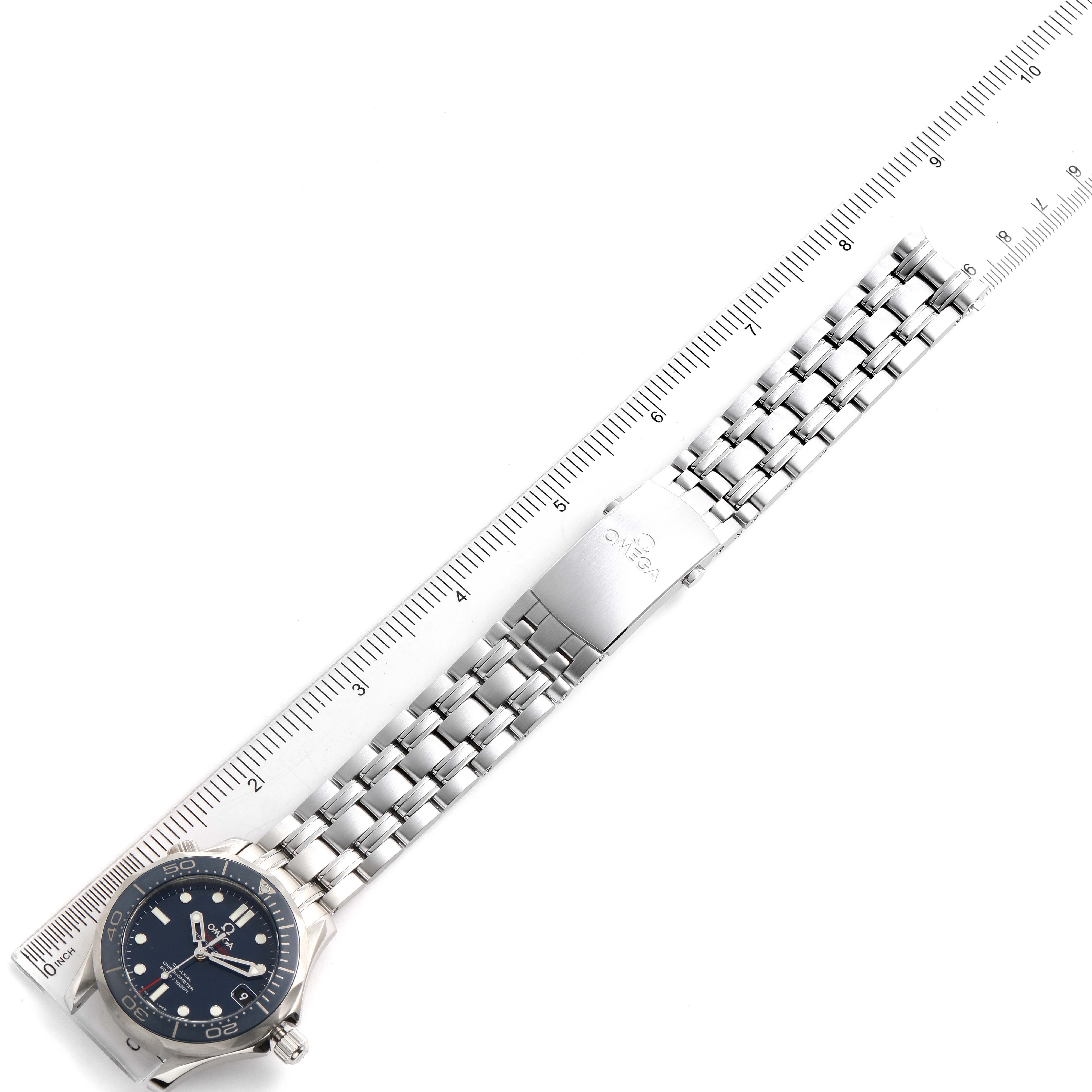 The image shows an Omega Seamaster 212.30.36.20.03.001 Men
s Stainless Steel Blue Dial 212.30.36.20.03.001 Men
s Stainless Steel Blue Dial watch from a top-down angle, displaying the face, bracelet, and clasp beside a ruler for measurement.