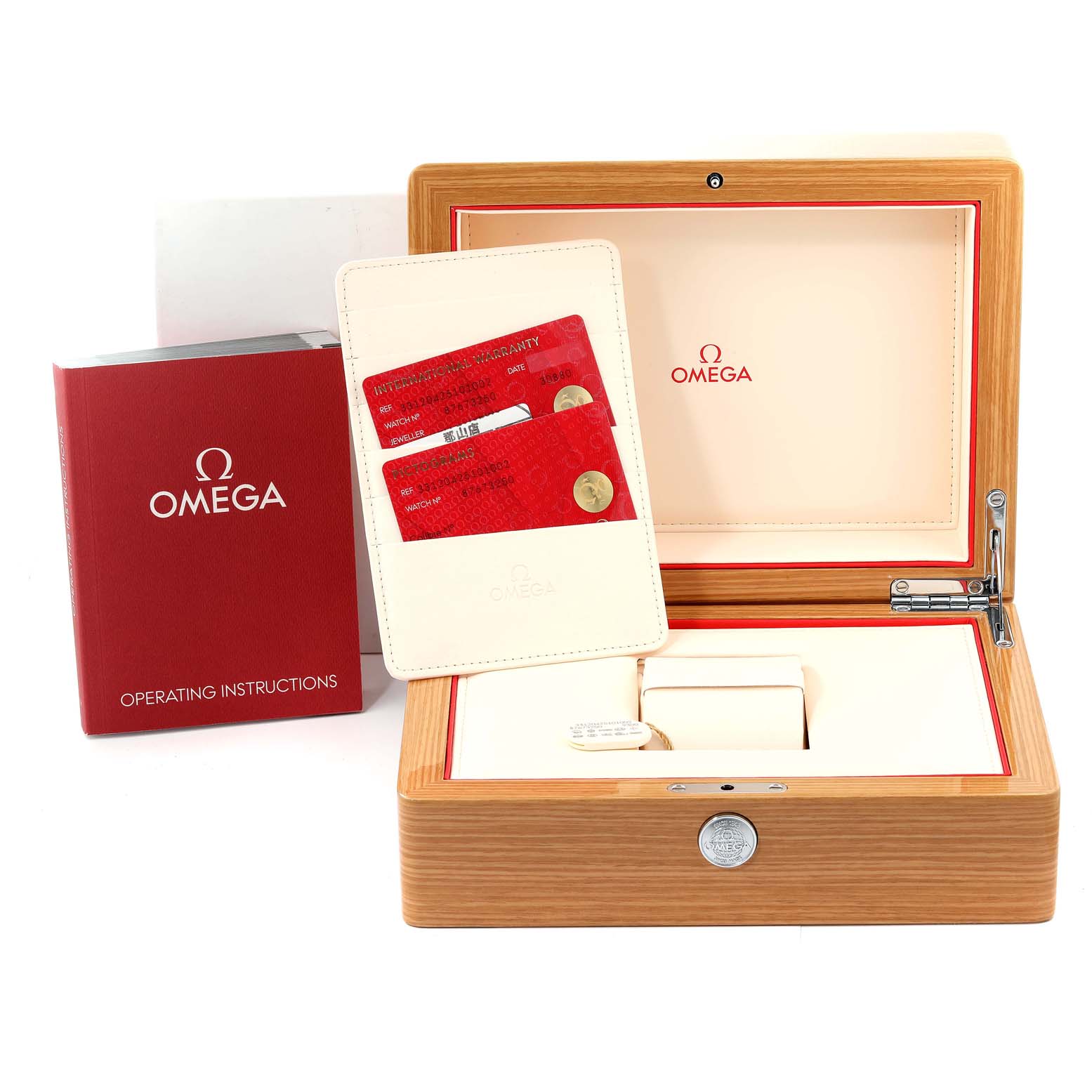 This image shows accessories for an Omega Speedmaster 331.20.42.51.01.002 Men's Steel and Gold (two tone) Black Dial 331.20.42.51.01.002 Men's Steel and Gold (two tone) Black Dial, including its box, operating manual, and warranty cards.