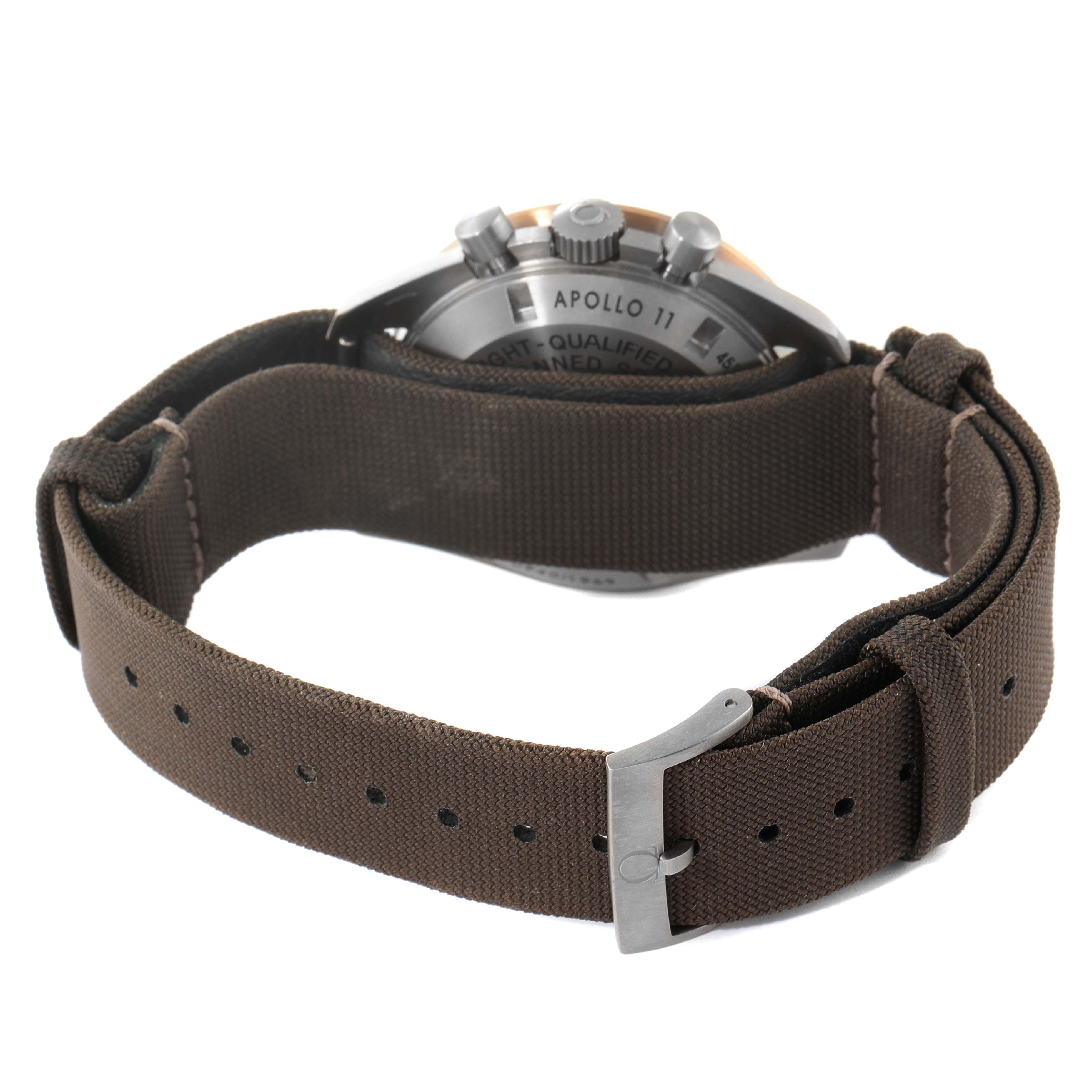 The image shows the back and side of an Omega Speedmaster 311.62.42.30.06.001 Men's Titanium Grey Dial 311.62.42.30.06.001 Men's Titanium Grey Dial watch with a brown strap and visible buckle.