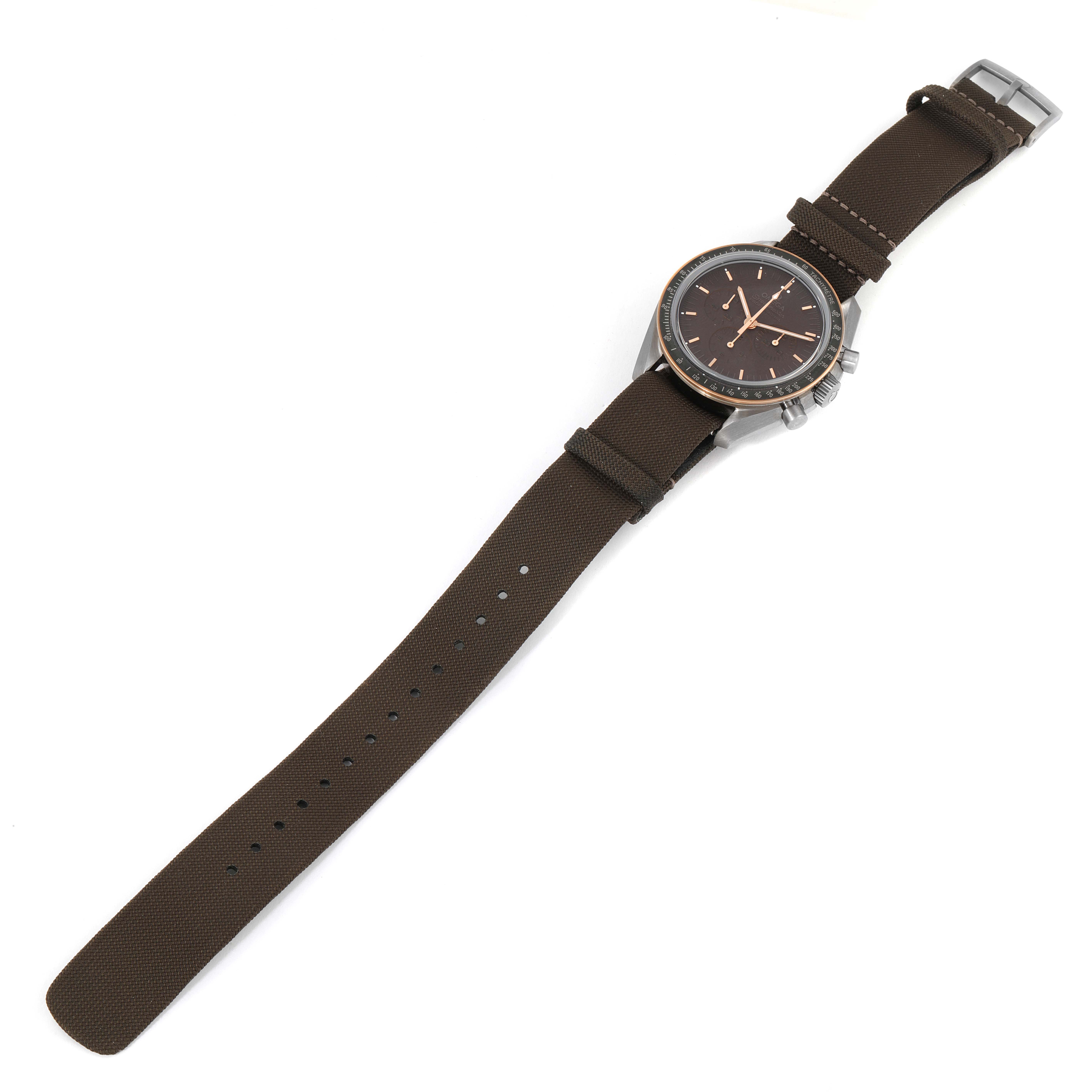 The image shows an Omega Speedmaster 311.62.42.30.06.001 Men's Titanium Grey Dial 311.62.42.30.06.001 Men's Titanium Grey Dial watch from a top-down angle, highlighting the face, bezel, and brown strap.