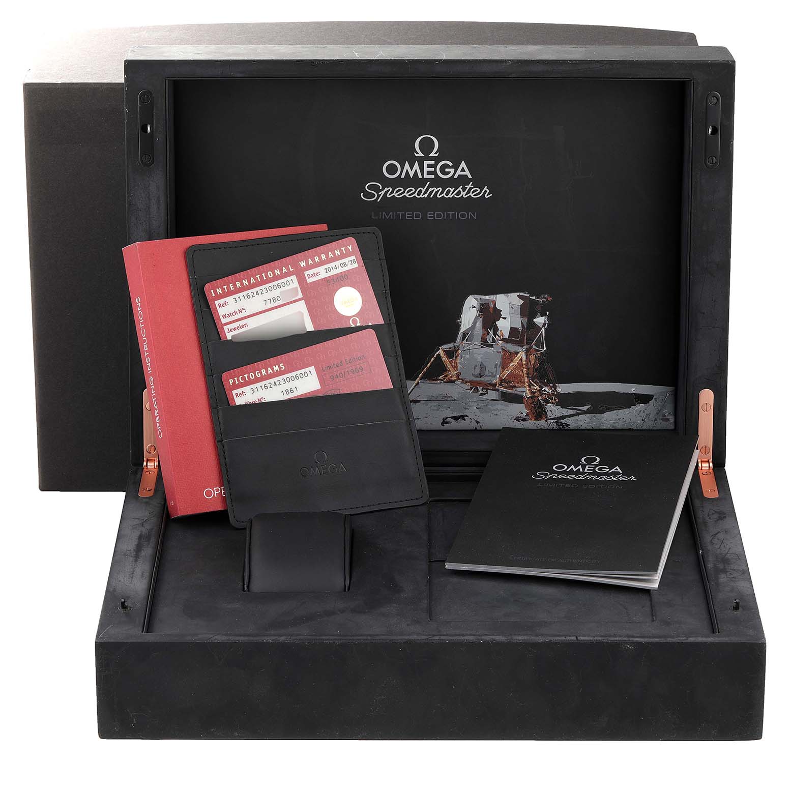 The image shows an Omega Speedmaster 311.62.42.30.06.001 Men's Titanium Grey Dial 311.62.42.30.06.001 Men's Titanium Grey Dial Limited Edition watch box with warranty cards and booklets inside.