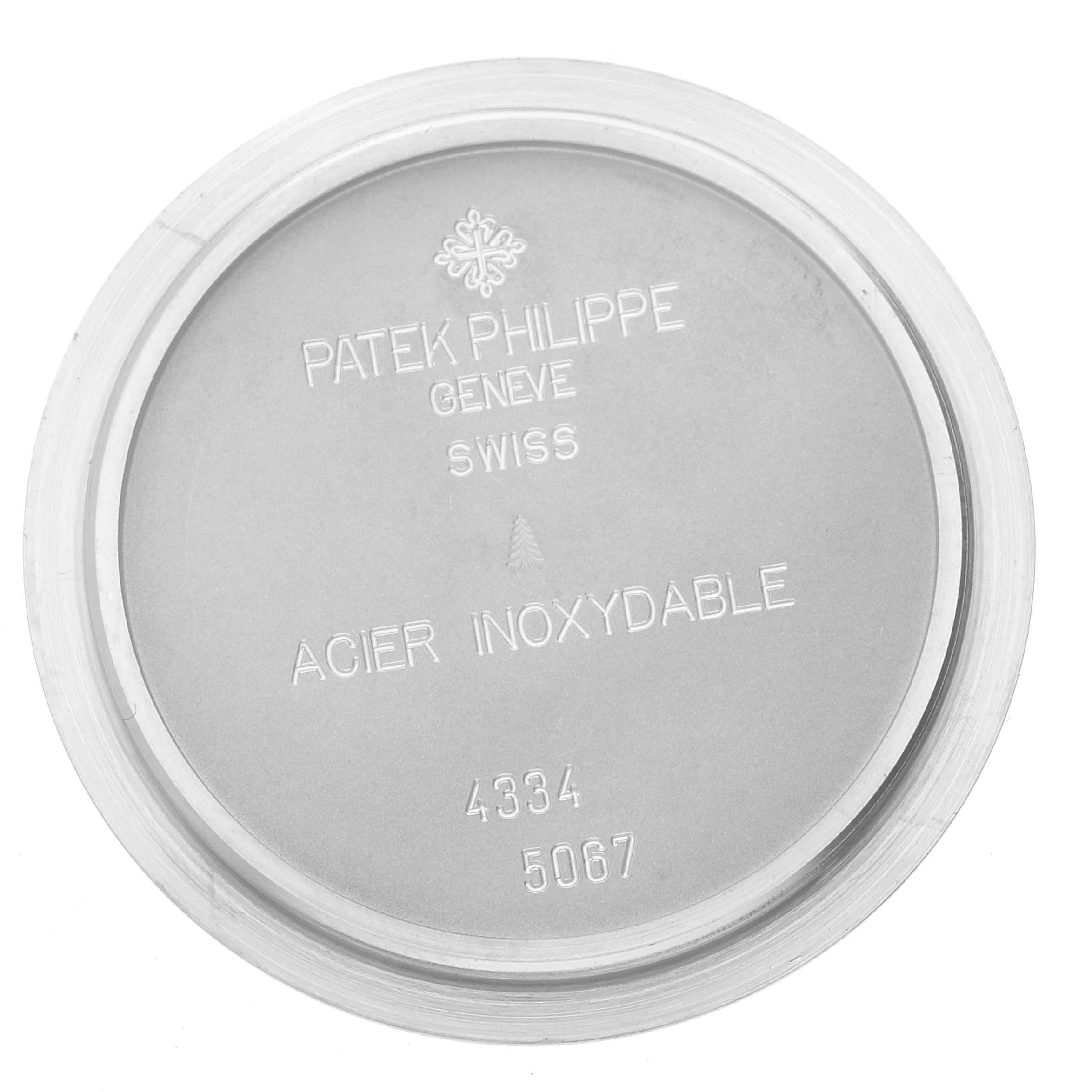 The image shows the back case of a Patek Philippe Aquanaut 5067A-027 Women's Stainless Steel Red Dial 5067A-027 Women's Stainless Steel Red Dial watch, highlighting brand engravings.