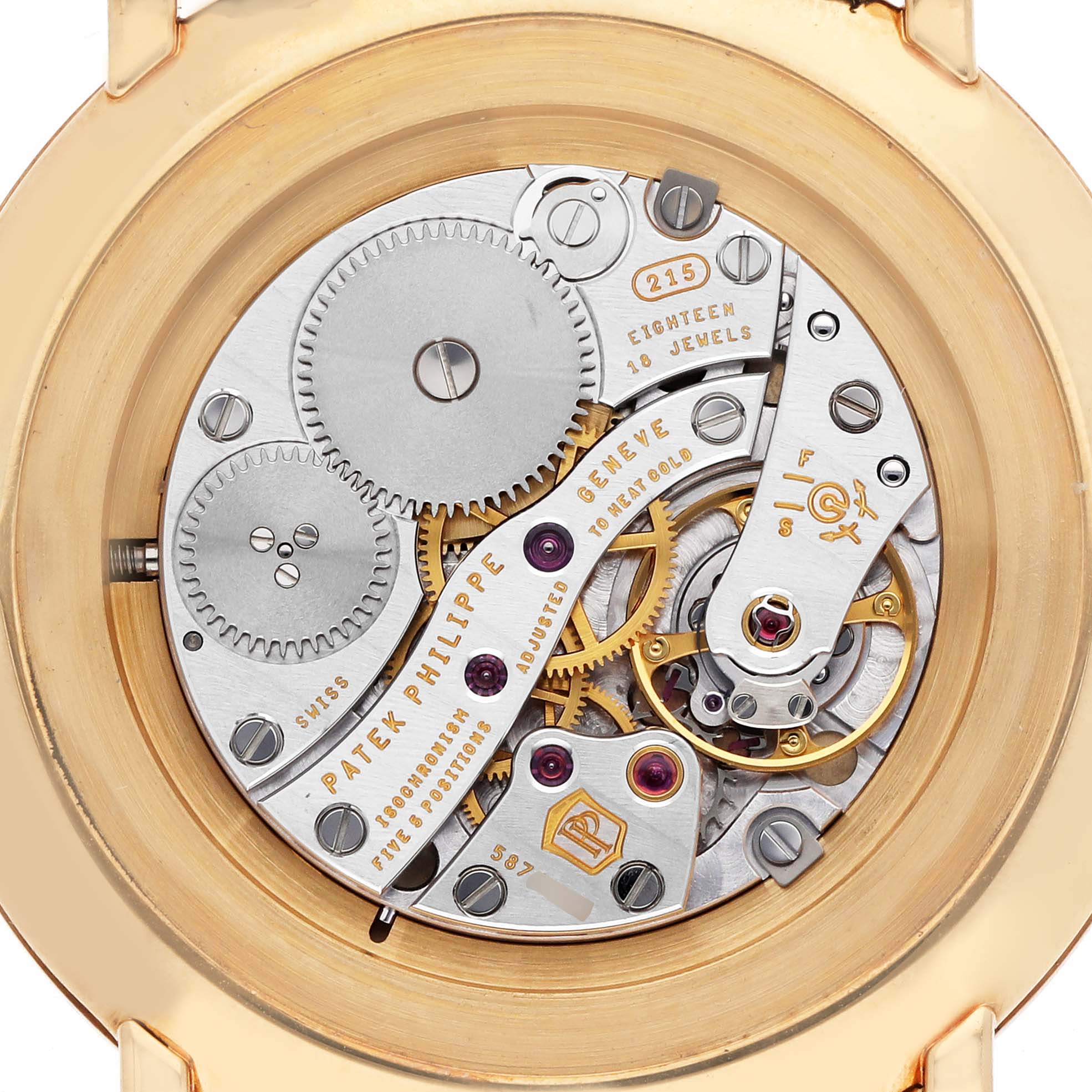 The image shows the movement of a Patek Philippe Calatrava 5119J-001 Men's Yellow Gold White Dial 5119J-001 Men's Yellow Gold White Dial watch viewed from the back, revealing gears and internal mechanisms.
