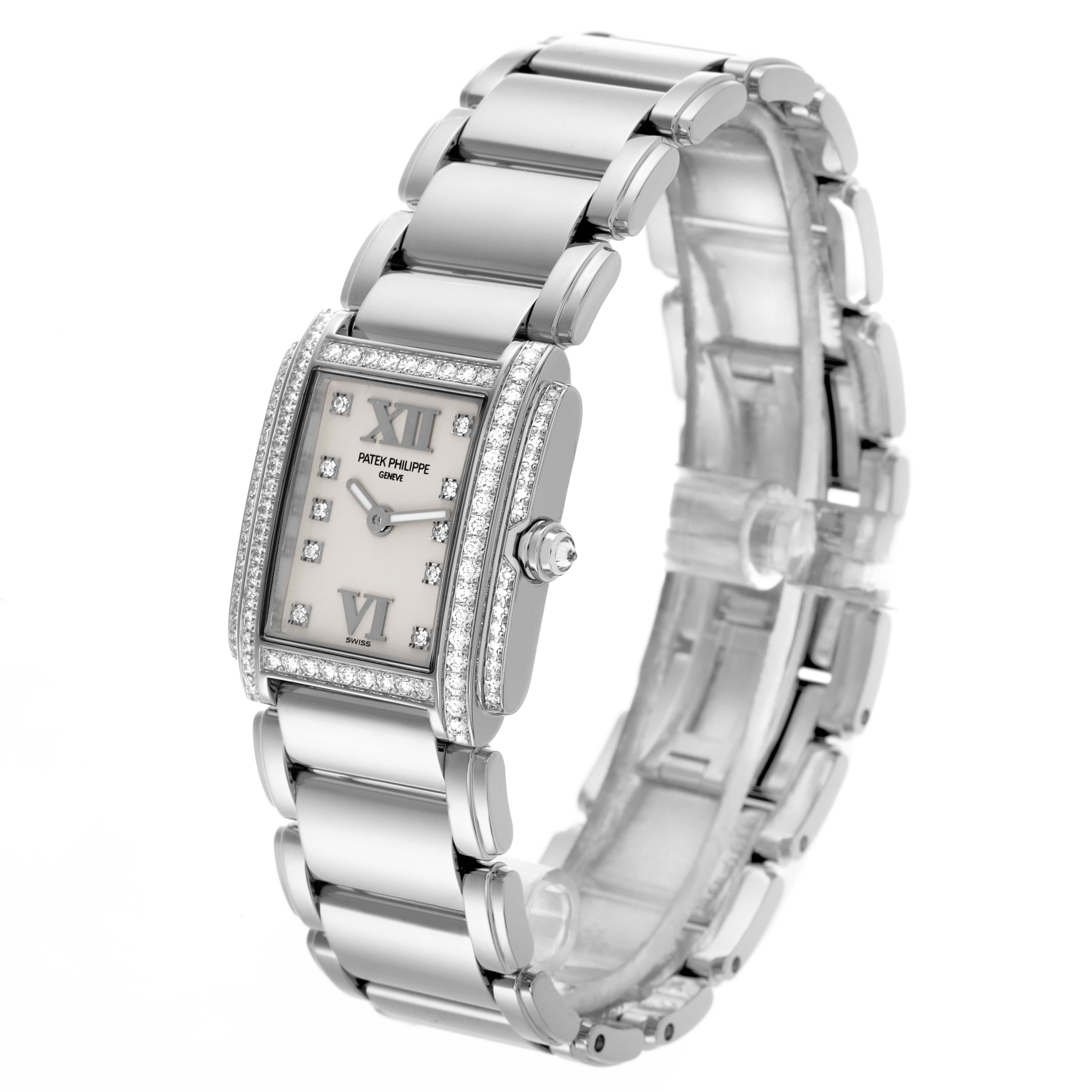 The Patek Philippe Twenty-4 4908/200G-011 Women's White Gold Silver Dial 4908/200G-011 Women's White Gold Silver Dial watch is shown at a three-quarter angle, highlighting the case, dial, diamond bezel, and bracelet.
