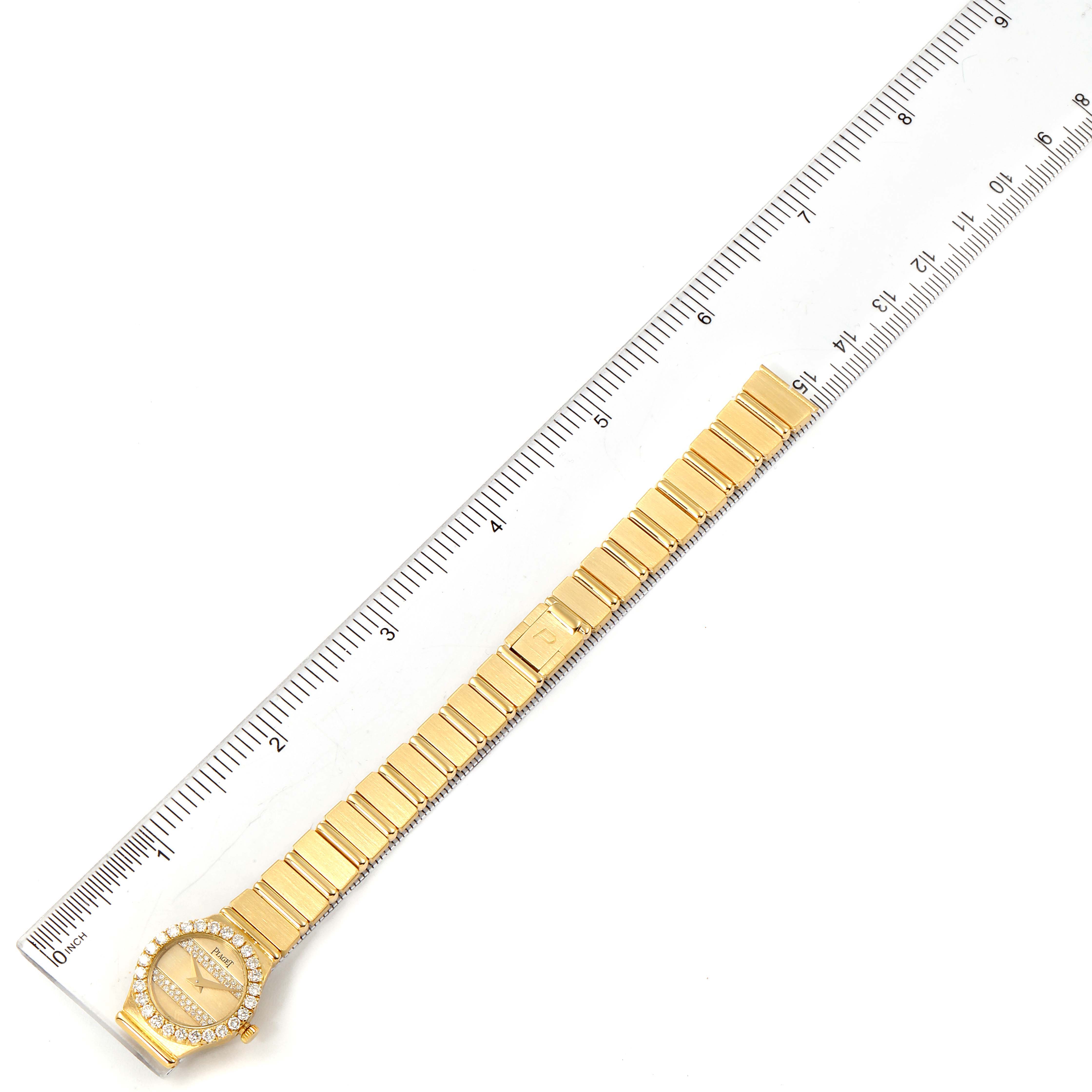 The Piaget  Women's Yellow Gold Champagne Dial  Women's Yellow Gold Champagne Dial Polo 18K Yellow Gold Diamond Dial Quartz Ladies Watch is shown from a top-down angle alongside a ruler.