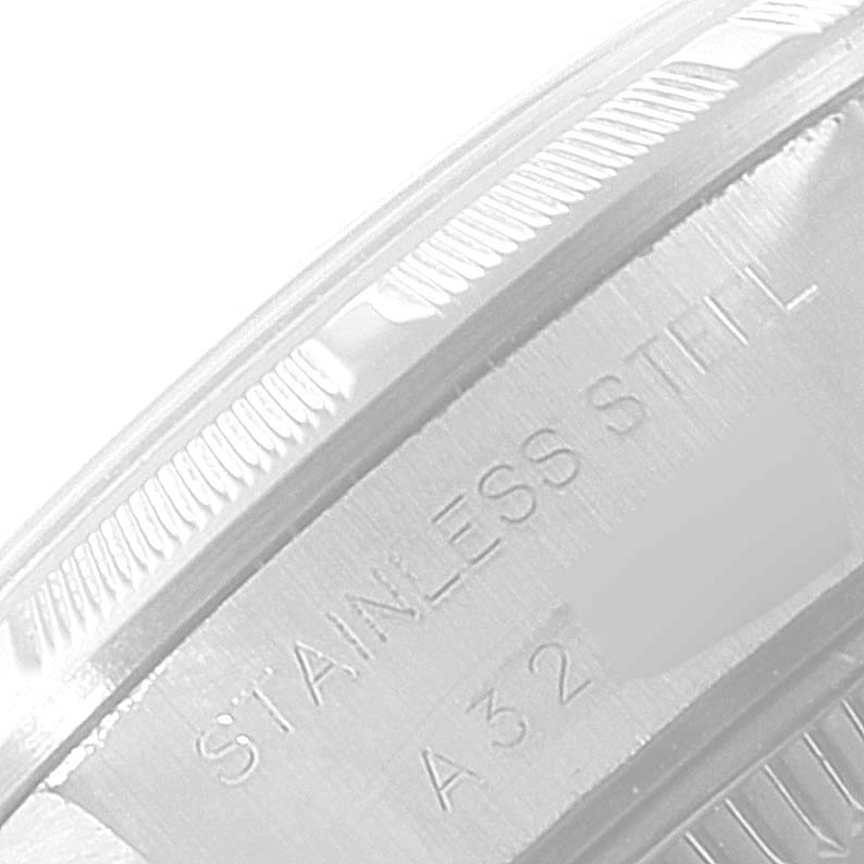 The image shows a close-up of the stainless steel outer bezel and part of the case back of a Rolex Date 69190 Women's Stainless Steel White Dial 69190 Women's Stainless Steel White Dial model watch.
