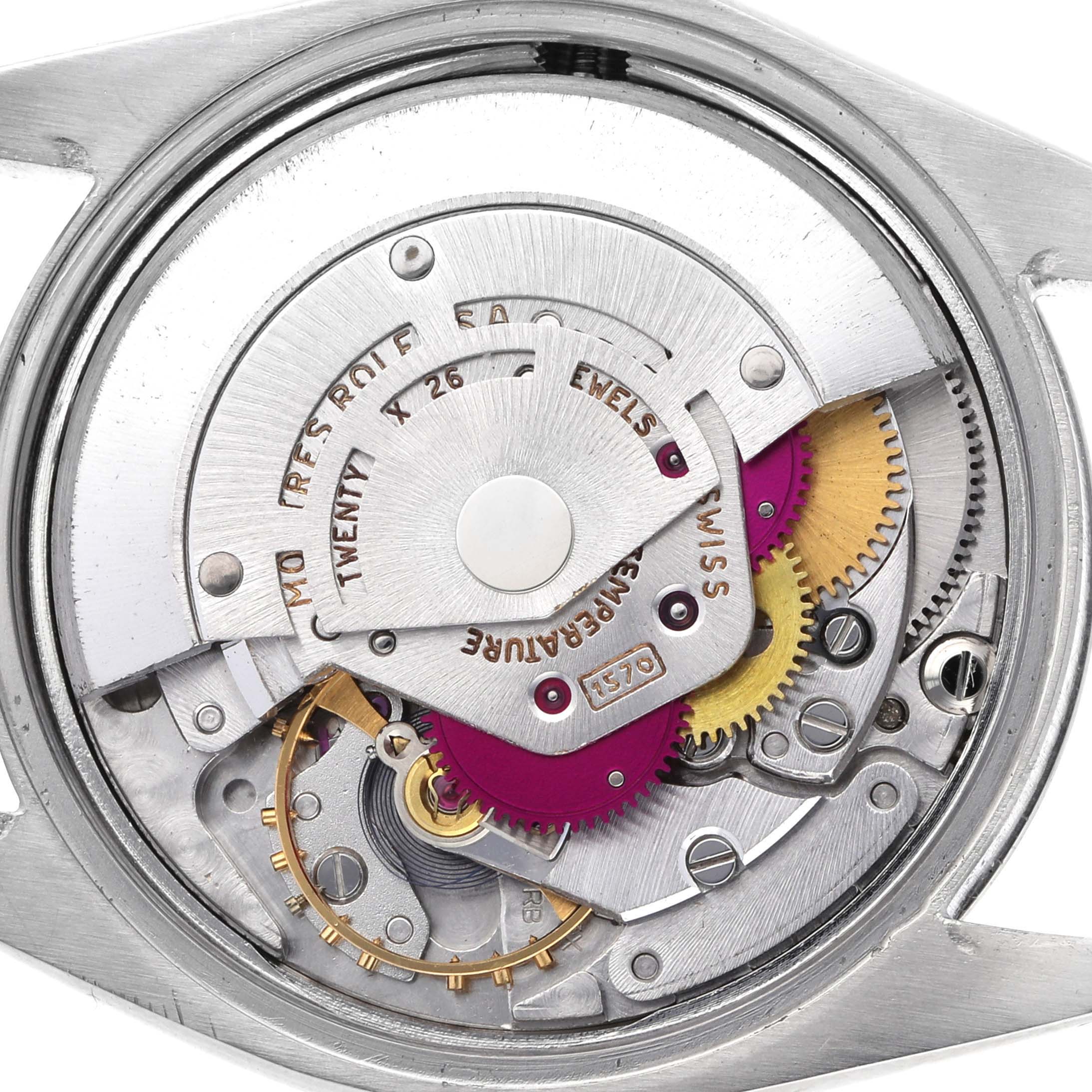 The image shows the movement of a Rolex Date 1500 Men's Stainless Steel Silver Dial 1500 Men's Stainless Steel Silver Dial model from a top-down angle, highlighting gears and mechanisms.