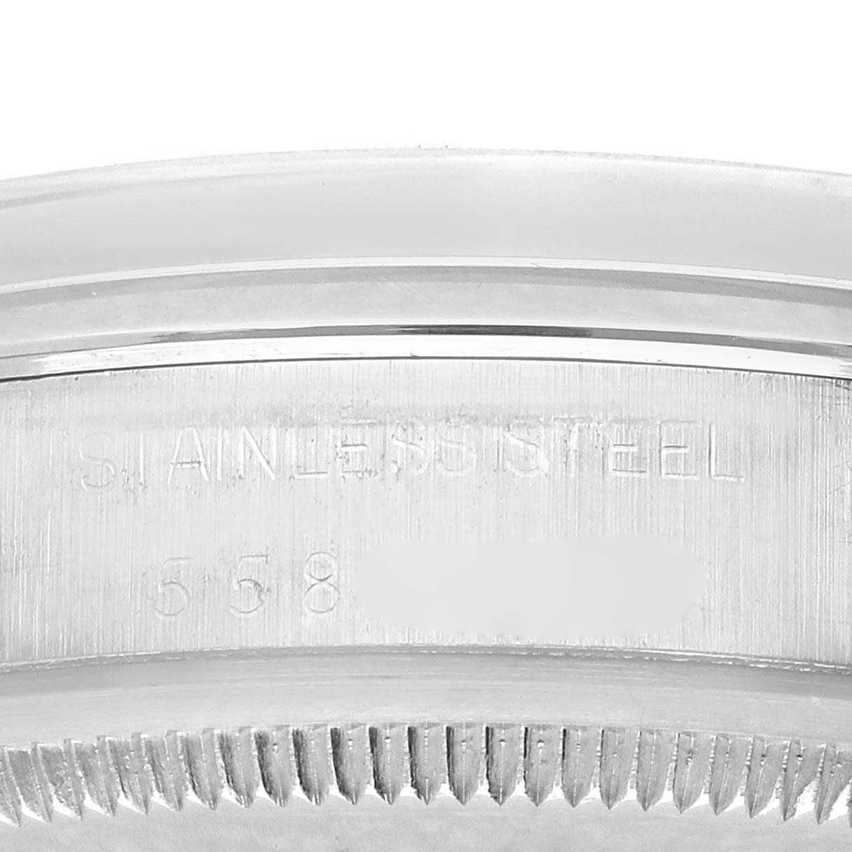 The image shows a close-up of the side of the Rolex Date 1500 Men's Stainless Steel Black Dial 1500 Men's Stainless Steel Black Dial model's case, highlighting the stainless steel engraving.