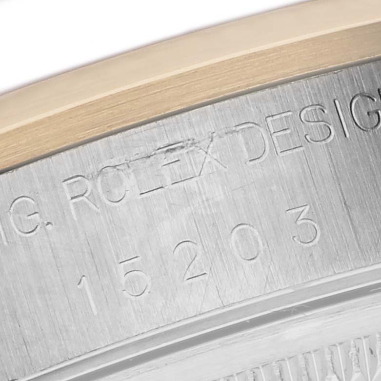 The image shows an engraved side view of the Rolex Date 15203 Men's Steel and Gold (two tone) Silver Dial 15203 Men's Steel and Gold (two tone) Silver Dial model watch, focusing on the case markings.